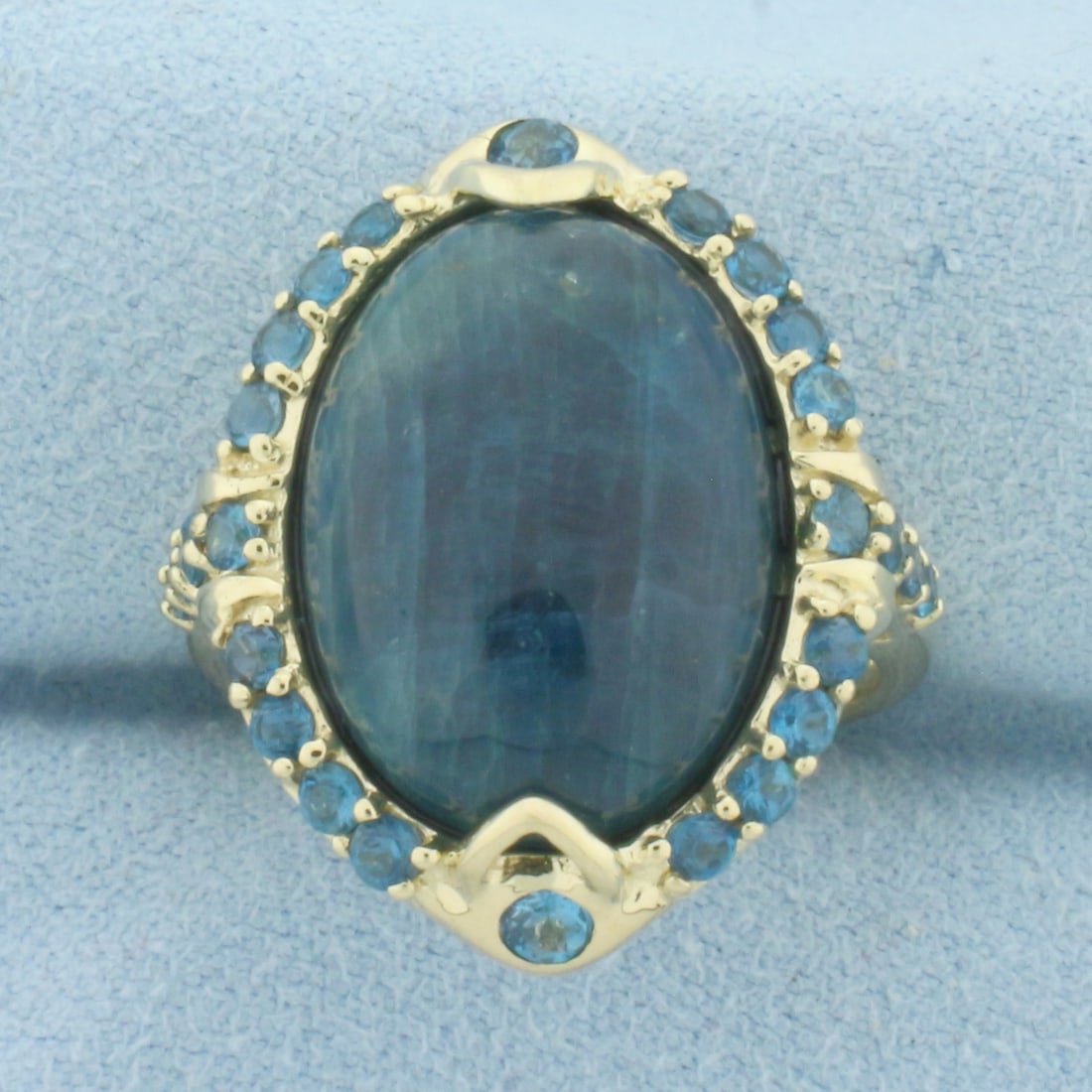 Jade and Blue Topaz Statement Ring in 10k Yellow Gold: In 10k Yellow Gold. Contains one 18x13mm high quality natural Jade gemstone with intense color. Also contains two 2.5mm and twenty-four 2mm high quality natural Blue Topaz gemstones with vibrant color