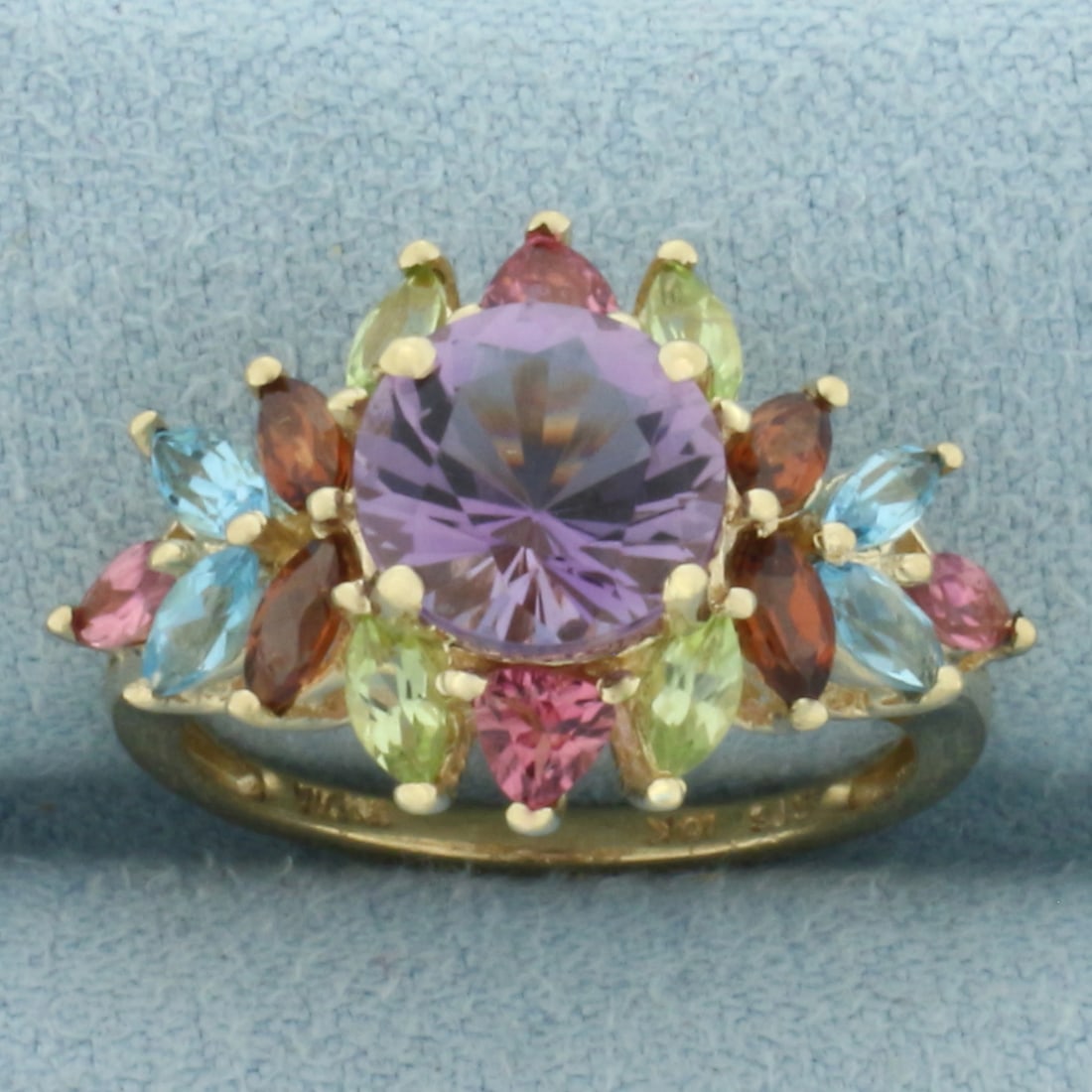 Rainbow Gemstone Ring in 10k Yellow Gold: In 10k Yellow Gold. Contains Amethyst, Pink Topaz, Peridot, Garnet, and Blue Topaz high quality natural gemstones with vibrant color and excellent clarity. 14.3mm wide at widest. Size 6.25. 3.3g.