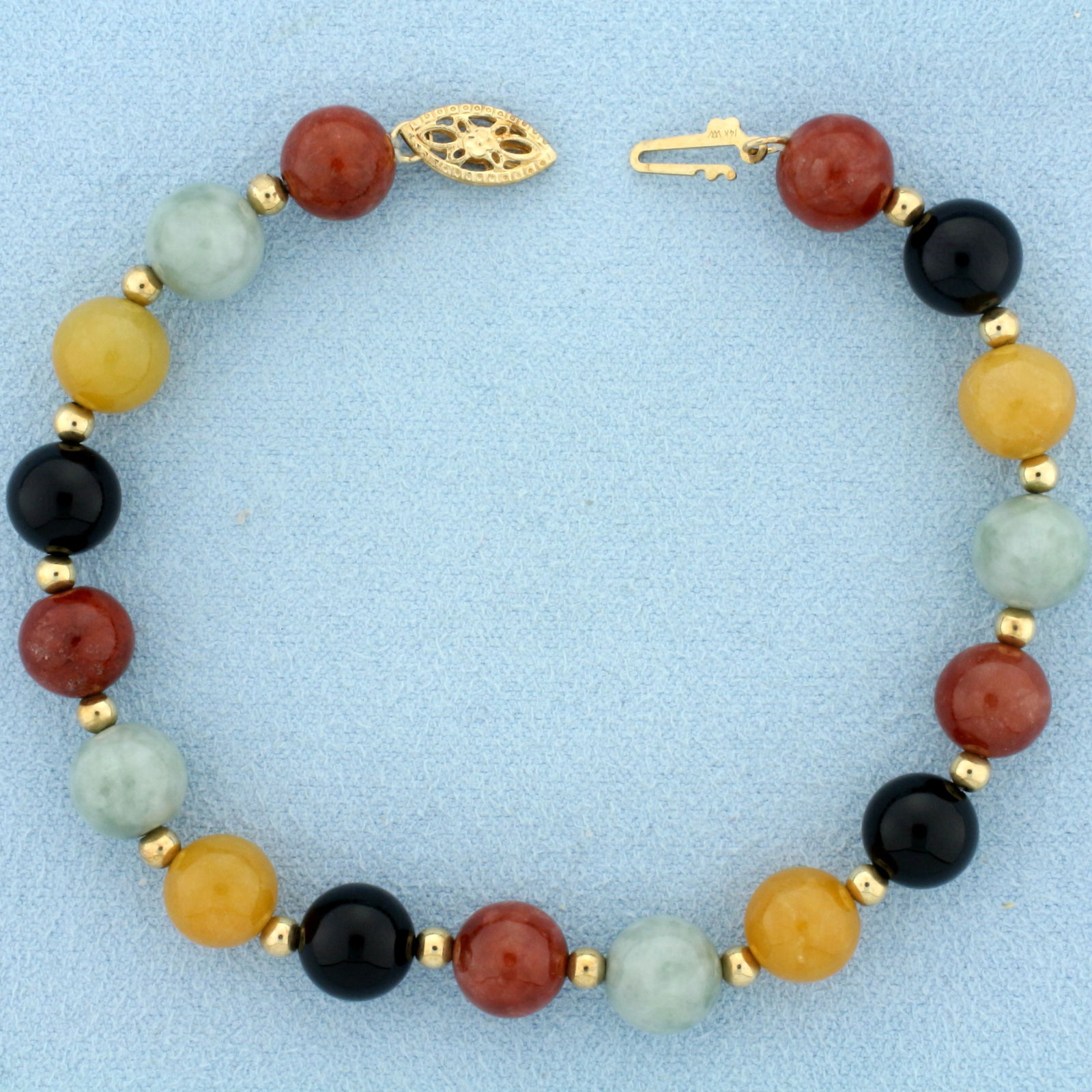 Multicolor Jade Ball Bead Bracelet in 14k Yellow Gold: In 14k yellow gold. Contains seventeen 8mm high quality natural green, red, black, and yellow jade ball beads with vibrant color. Also contains sixteen 2.85mm gold ball beads. 7.5 inch long. 14.8g.
