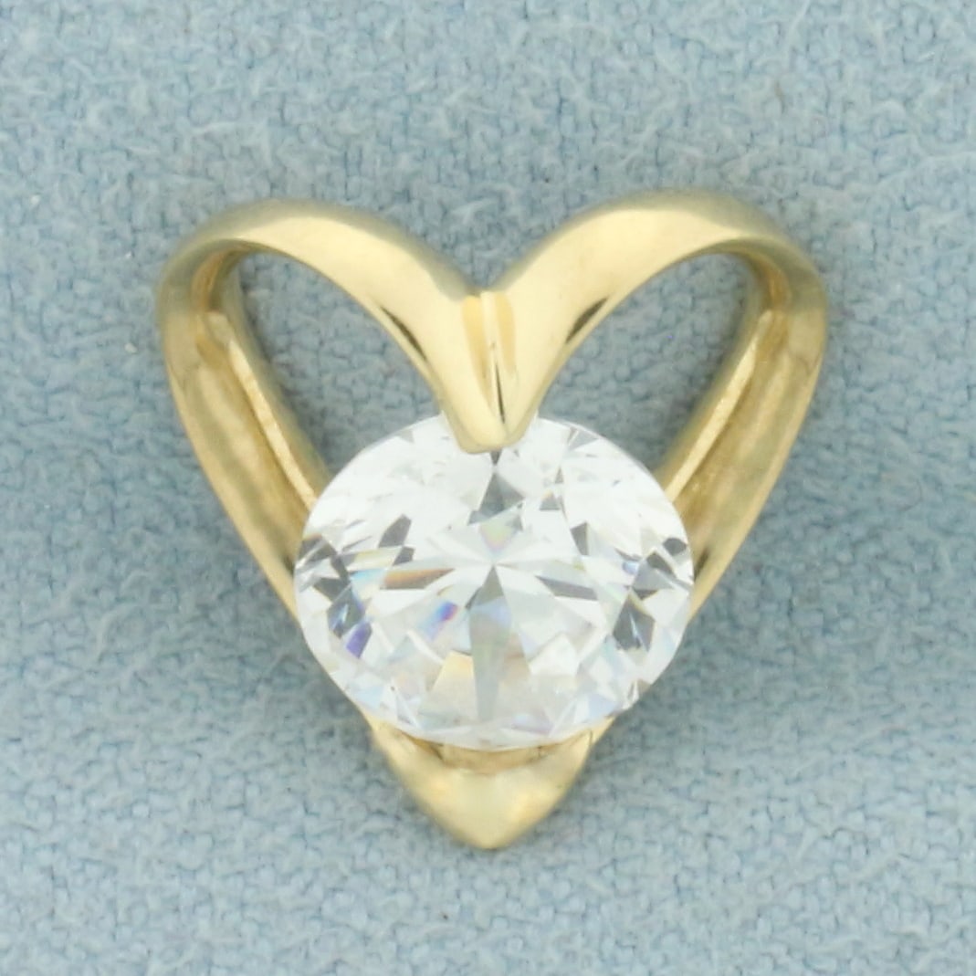CZ Heart Slide Pendant in 14k Yellow Gold: In 14k yellow gold. 1/2 inches long by 1/2 inches wide. Contains one 8mm high quality CZ gemstone with excellent cut and clarity for extra sparkle. 2.0g.