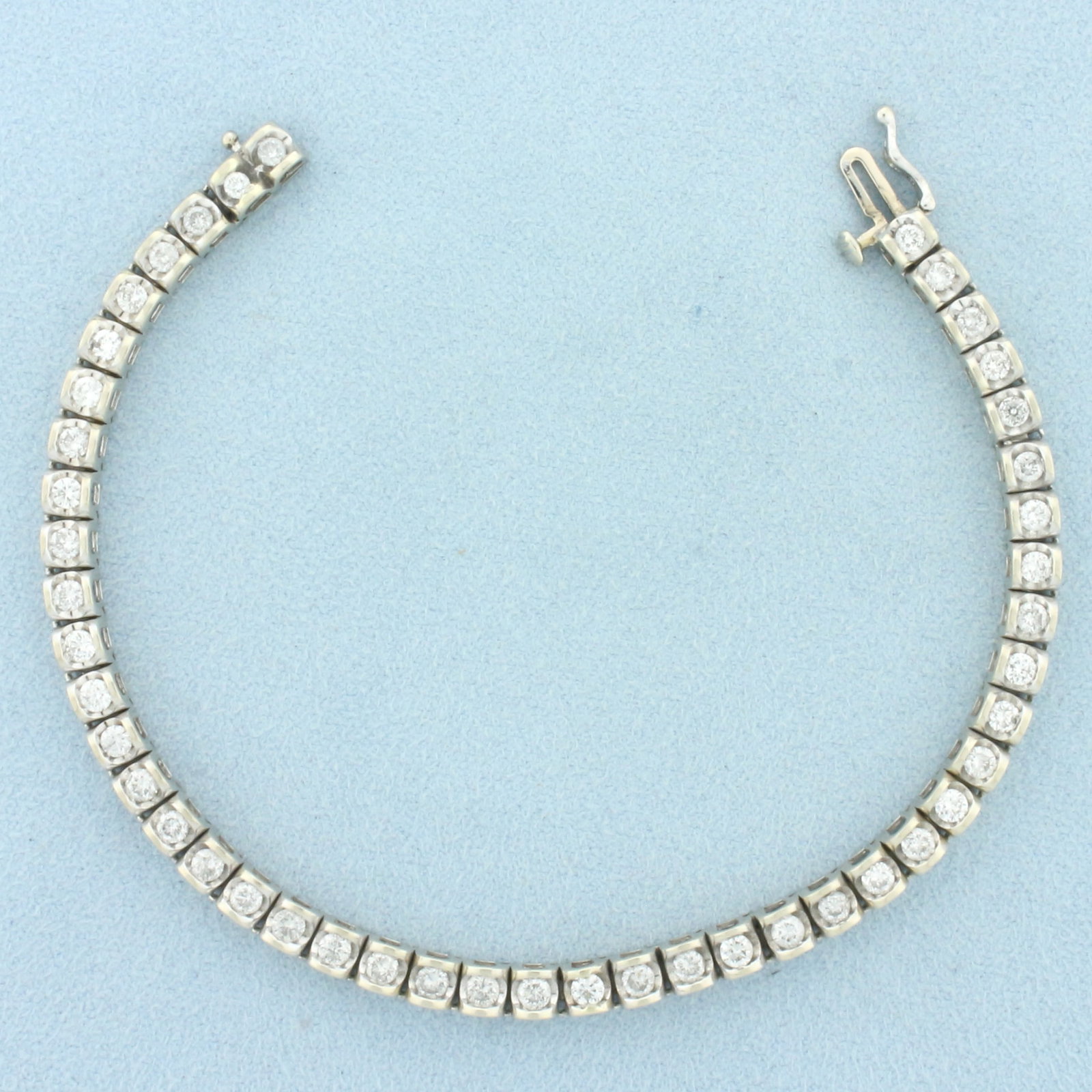 3ct Diamond Tennis Bracelet in 14k White Gold: In 14k White Gold. Contains forty-five high quality diamonds, 3ct TW, I clarity/I color, great cut for added brilliance. 7 3/8 inches long. 4mm wide. Concealed slide clasp with safety latch. 17.1g.