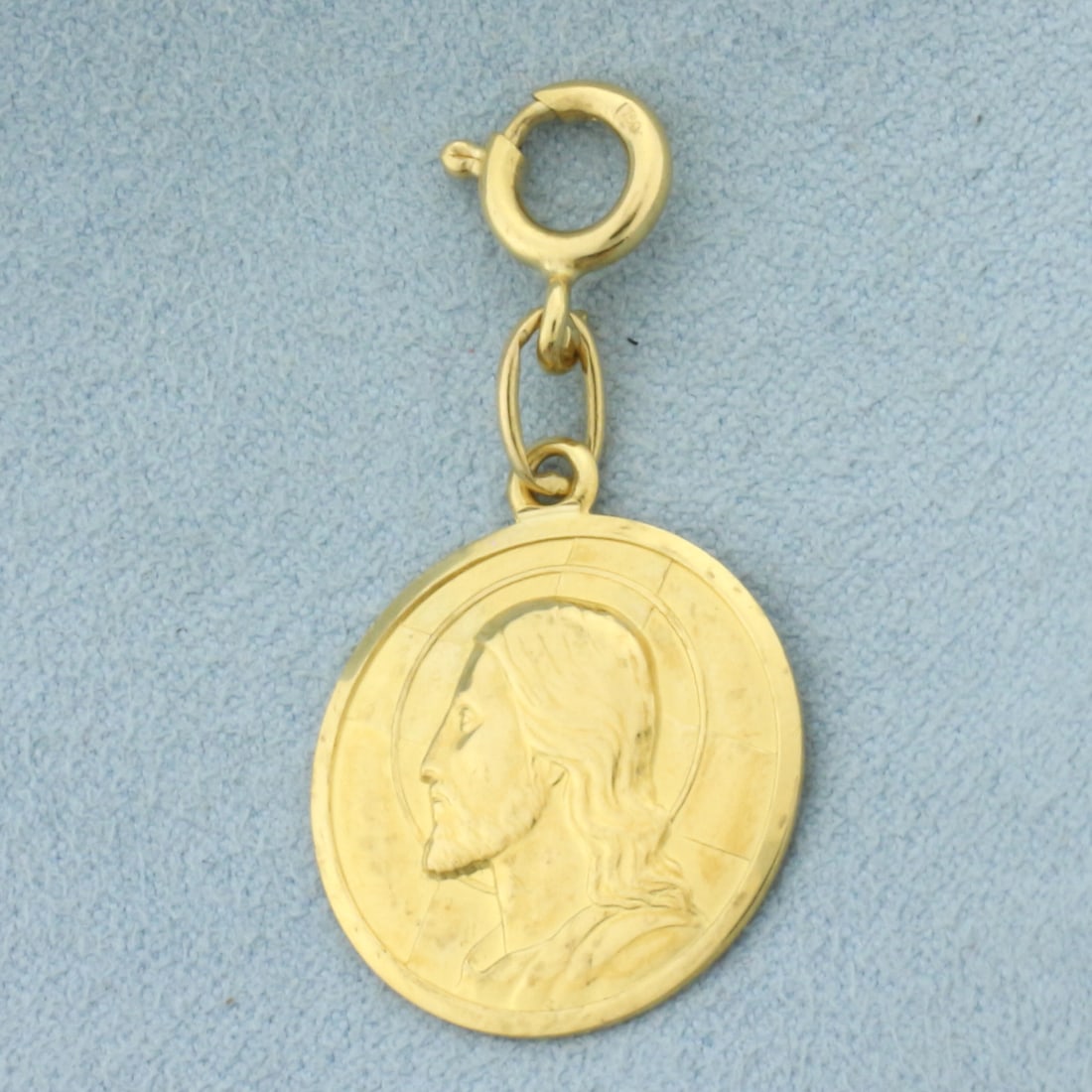 Jesus Spanish Protection Medallion Charm in 18k Yellow Gold: In 18k Yellow Gold. "DIO TI PROTEGA" written on back. 1 1/8 inches long including jump ring. 7/8 inch wide. Spring clasp to clip charm bracelet or necklace without need to solder on. 4.6g.