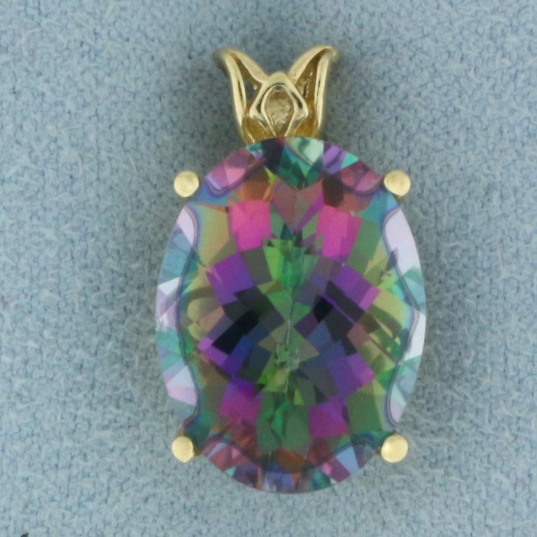 10ct Mystic Topaz Pendant in 14k Yellow Gold: In 14k Yellow Gold. Contains one high quality 16mmx12mm 10ct oval checkerboard cut mystic topaz with intense color and excellent clarity. 3/4 inch long. 1/2 inch wide. 4.3g.