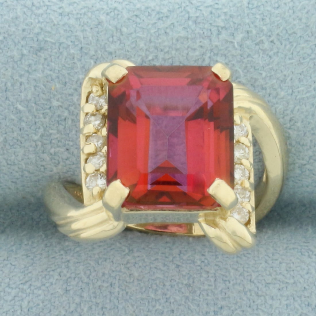 Rubellite Tourmaline and Diamond Bypass Ring in 14k Yellow Gold: In 14k Yellow Gold. Contains one 12mmx10mm high quality natural Rubellite Tourmaline gemstone, approximately 6ct, with intense ruby red color and excellent clarity. Also contains ten .02ct high qualit