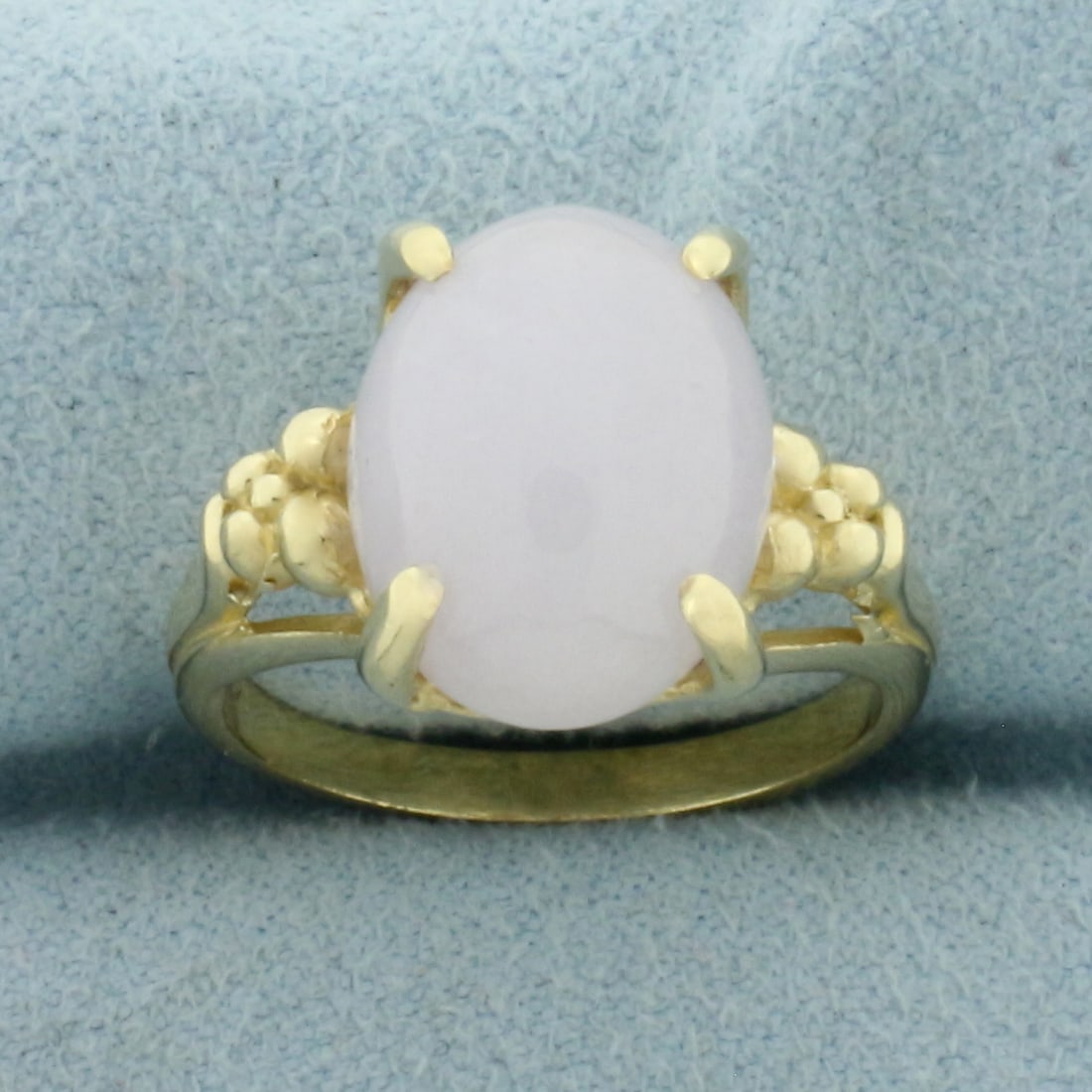 Lavendar Jade Solitaire Ring in 14k Yellow Gold: In 14k Yellow Gold. Contains one 13 by 10mm high quality natural Jade gemstone with beautiful light lavender color. Size 6.5. 5.2g.
