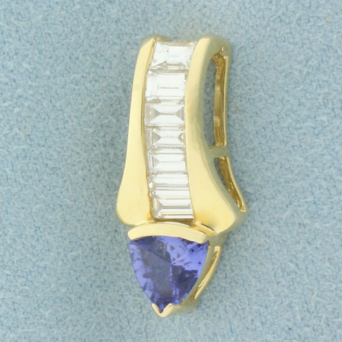AAA Tanzanite and Diamond Pendant or Slide in 14k Yellow Gold: In 14k Yellow Gold. Contains one 6.5mm AAA quality natural Tanzanite gemstone, approximately 3/4ct, with intense sapphire like color and excellent clarity. Also contains seven high quality baguette di