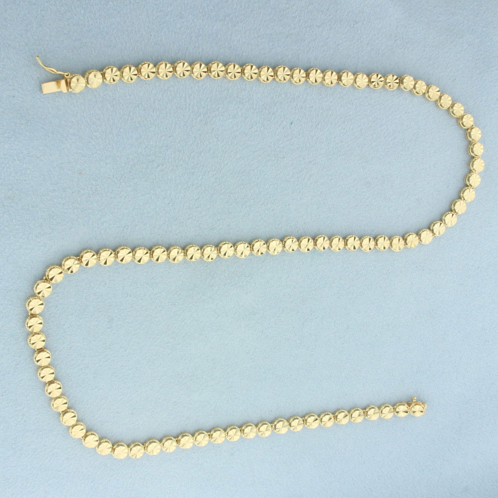 17 Inch Diamond Cut Disc Link Necklace in 14k Yellow Gold: In 14k Yellow Gold. 17 inches long. 4.8mm wide. Diamond cut disc links for added sparkle. Concealed slide clasp with safety latch. 14.0g.