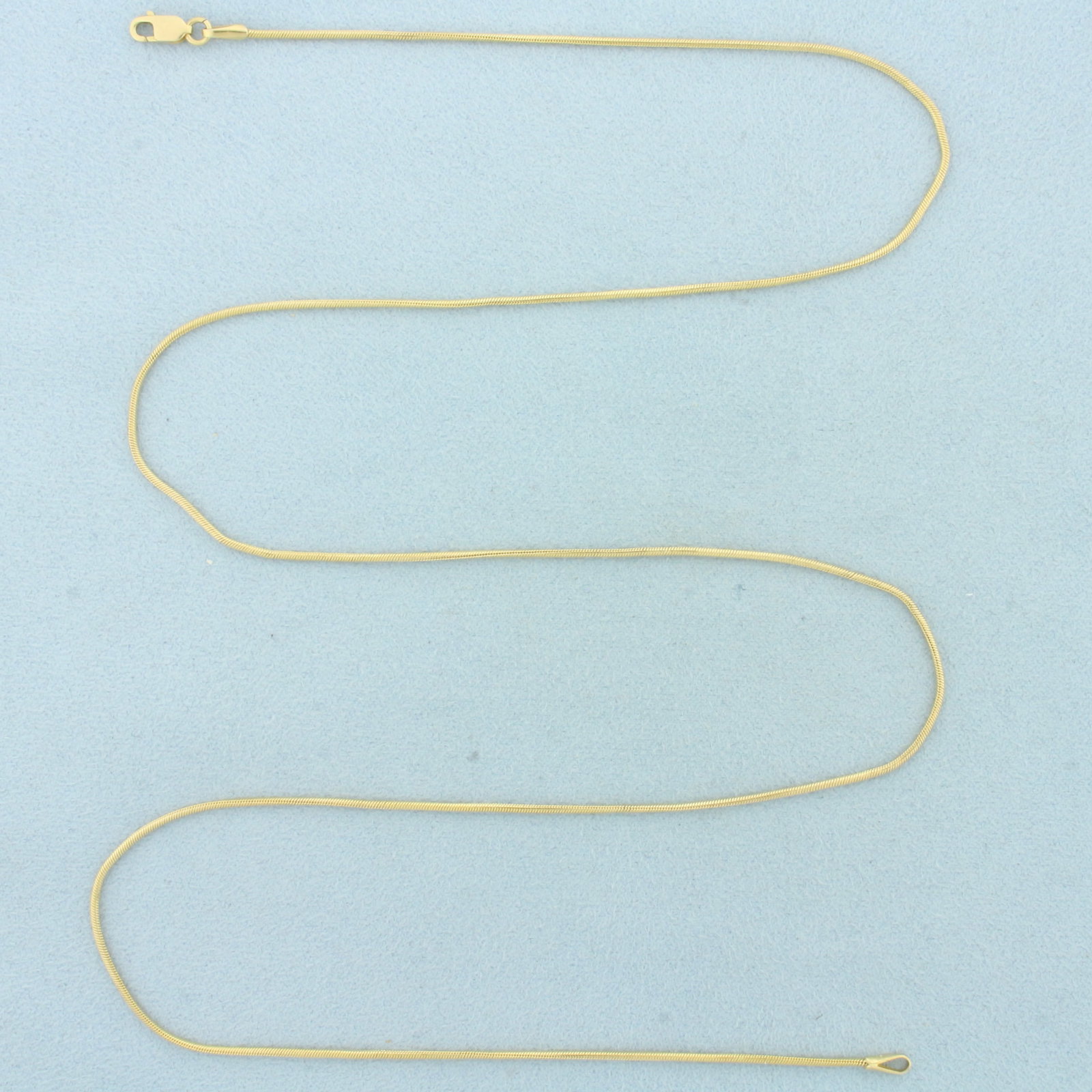 Italian 23 Inch Snake Link Chain Necklace in 14k Yellow Gold: In 14k Yellow Gold. 23 inches long. 1.2mm wide. Snake link. Made in Italy. Lobster clasp. 5.4g.