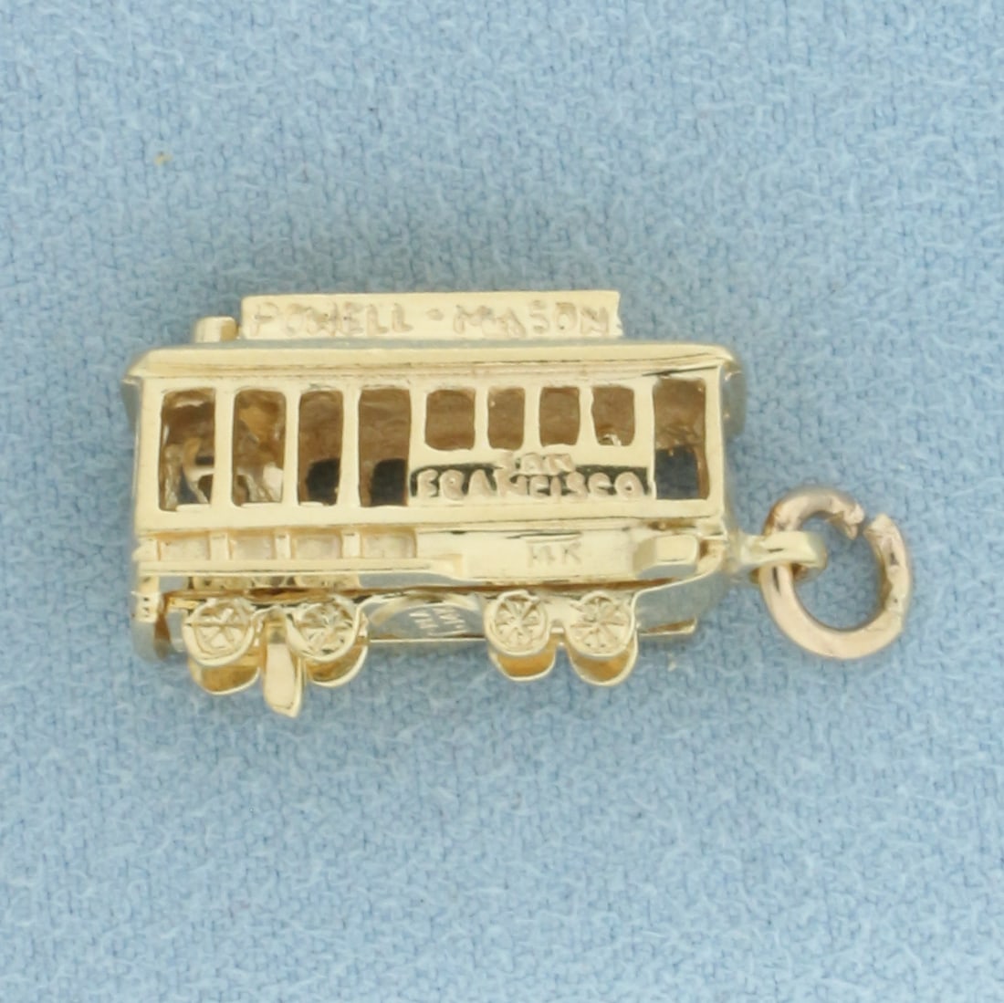 Powell Mason San Francisco Cable Car Charm in 14k Yellow Gold: In 14k Yellow Gold.7/8 inch long. 3/8 inch wide. Mechanical - operator moves back and forth when roll charm. 6.5g.