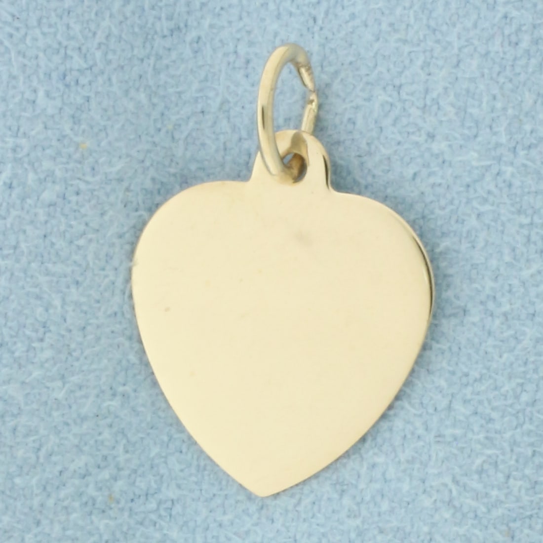 Engravable Heart Charm in 14k Yellow Gold: In 14k Yellow Gold. 3/4 inch long (including jump ring). 1/2 inch wide. .9g.