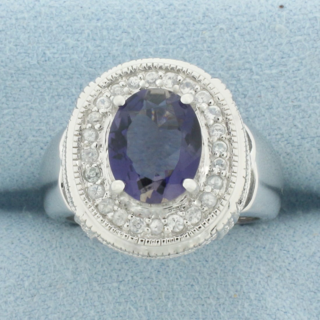 Tanzanite and Diamond Statement Ring in 10k White Gold: In 10k White Gold. Contains one 8x10mm high quality Tanzanite gemstone, approximately 3cts, with intense color and excellent clarity. Also contains twenty-four high quality 1/2pt diamonds. 6.8g.