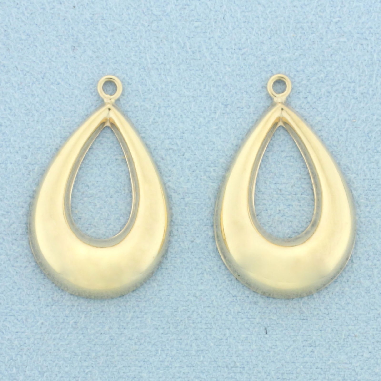 Stud Earring Enhancers Jackets in 14k Yellow Gold: In 14k Yellow Gold. 1 inch long. 5/8 inch wide each. Designed to fit around stud earrings to give a fresh new look. 2.0g.