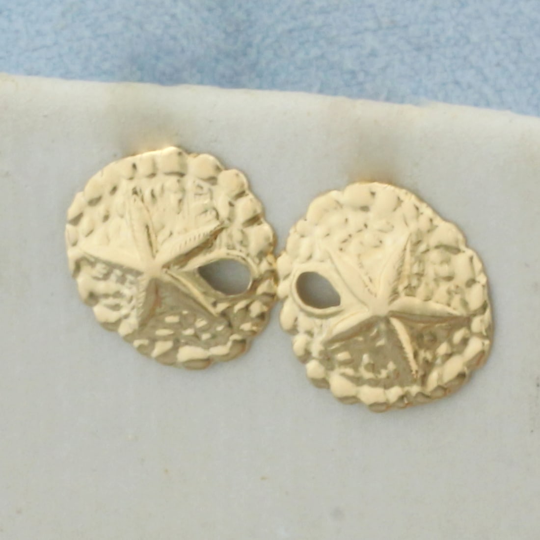 Sand Dollar Stud Earrings in 14k Yellow Gold: In 14k Yellow Gold. 3/8 inch diameter. Friction backs. .4g.