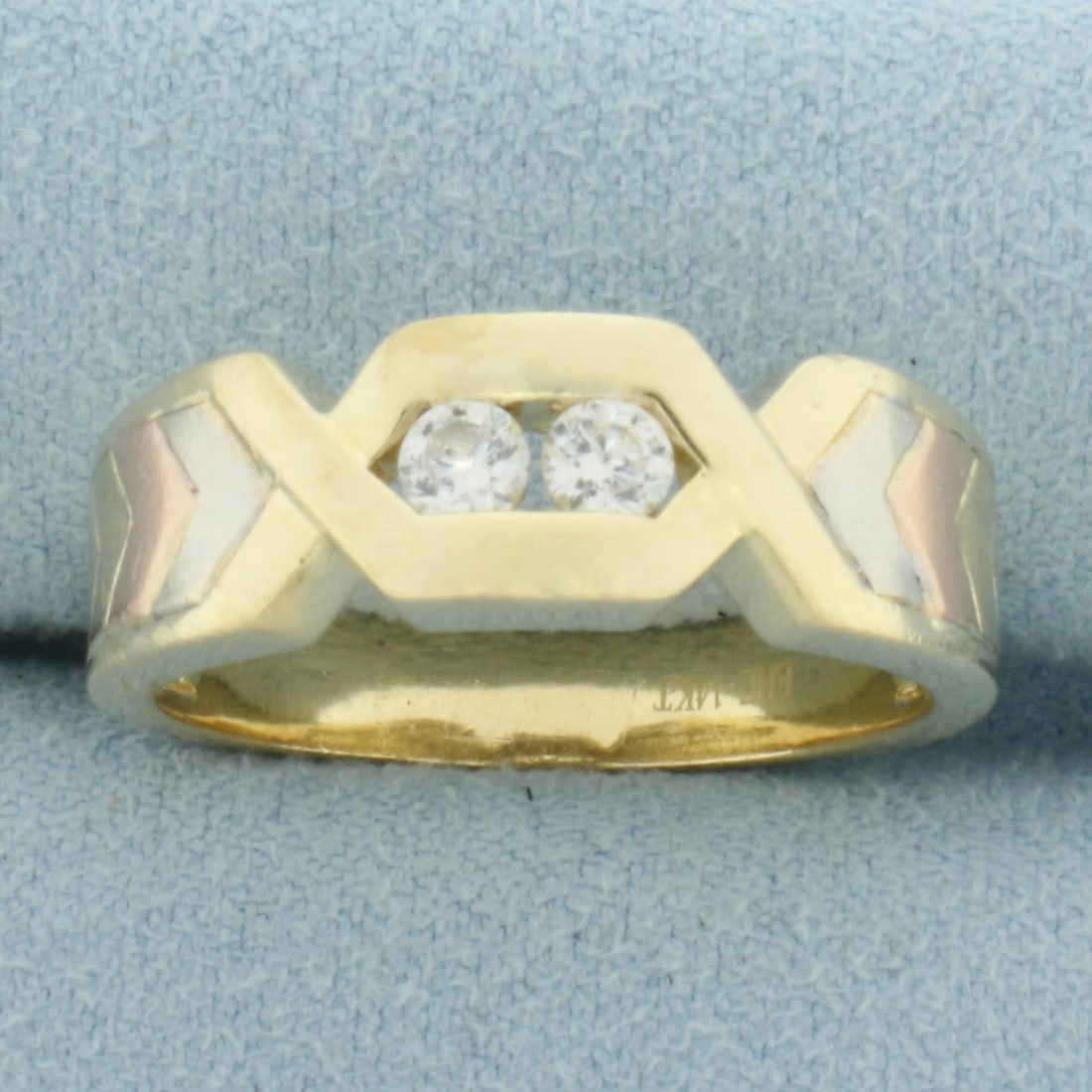 Tri-Color Chevron Design Ring in 14k Yellow, White, and Rose Gold: In 14k Yellow, White, and Rose Gold. Contains two 1/8ct high quality CZ gemstones with excellent cut and clarity for added sparkle. 7.4mm wide. Size 10.5. 6.6g.