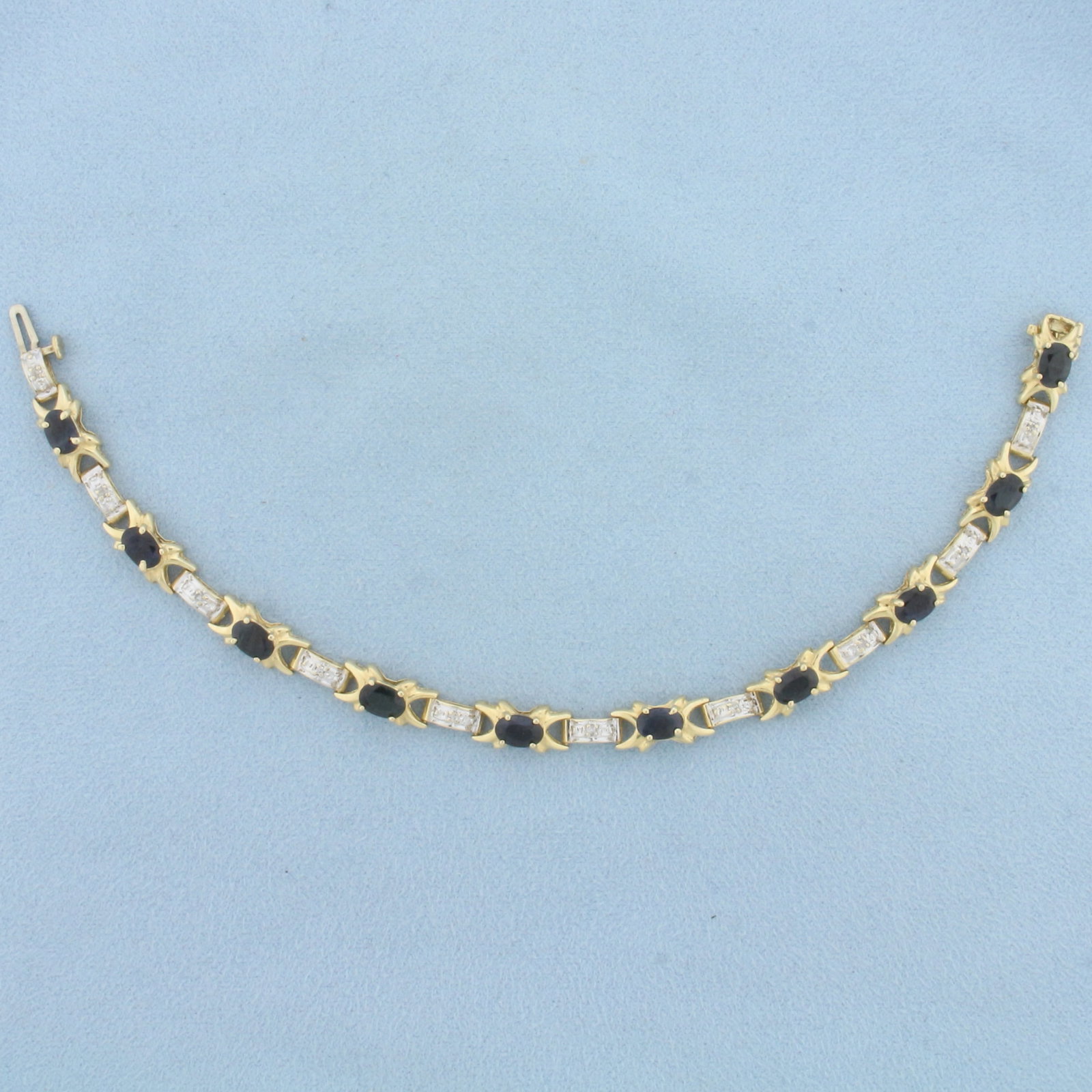 Natural Sapphire and Diamond Tennis Bracelet in 14K Yellow Gold: In 14K Yellow Gold. Contains ten high quality natural 4mmx6mm oval cut Sapphire gemstones with deep blue color and excellent clarity. Also contains ten high quality 1/2pt Diamonds. 7 inches long. 6.4m