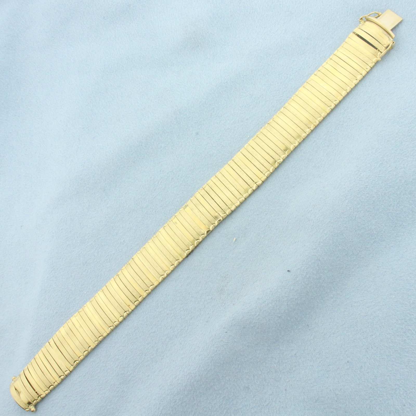 Italian Omega Link Bracelet in 14K Yellow Gold: in 14K Yellow Gold. Safety clasp. 7 1/4 inches long. 14.8mm wide. Alternate links are diamond cut for unique look. 23.4g