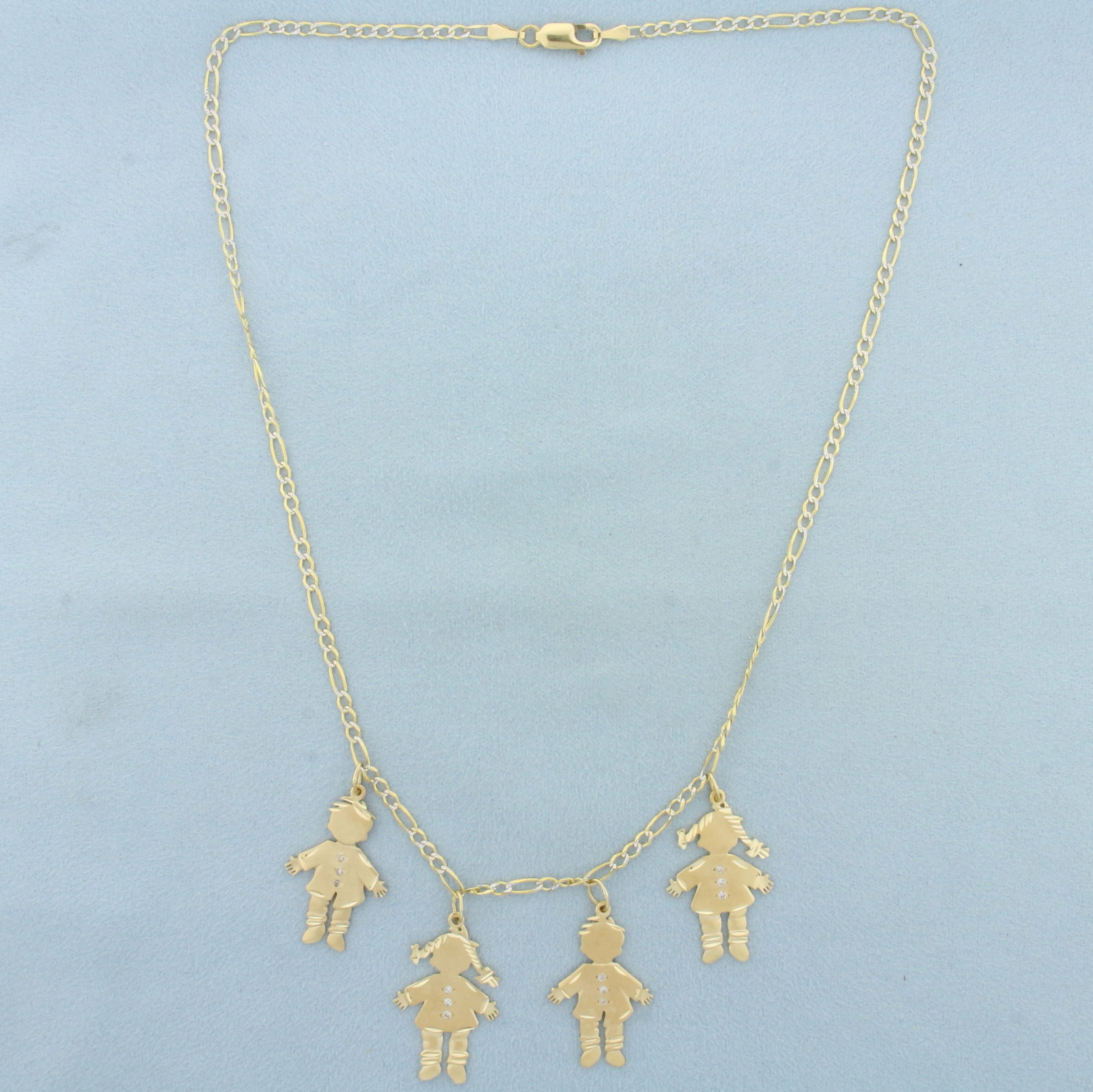 Diamond Children or Grandchildren Charm Necklace in 14k Yellow Gold: In 14k yellow gold. Italian made. 18 inches long. 2.5mm wide diamond cut figaro chain gives the look of diamonds set in link. 2 girl and 2 boy charms (1 1/8 inches long x 5/8 inches wide each). Accent