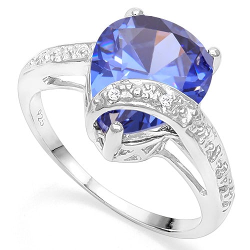 Large 3D Lab Tanzanite & Diamond Ring in Sterling Silver: In platinum over .925 sterling silver. Contains 1 lab tanzanite, 7.22cts, with excellent color and clarity. Accented with 2 genuine diamonds, .01ctw. Size 8. 4.2g