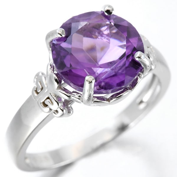 Large Amethyst Solitaire Statement Ring in Sterling Silver: In platinum over .925 sterling silver. Contains one 3.3ct amethyst gemstone. Size 7. 4.6g