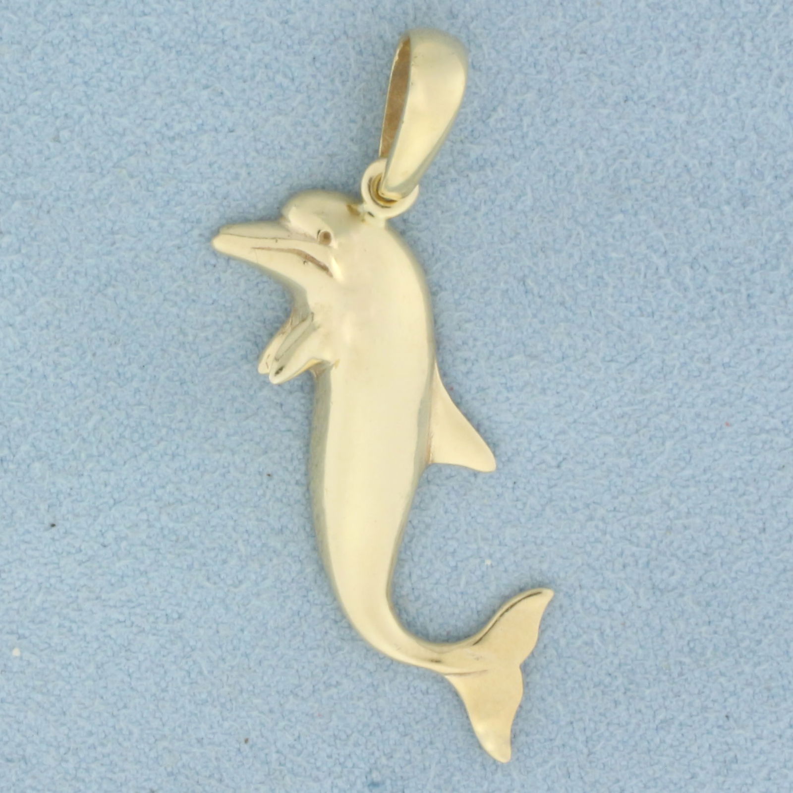 Dolphin Pendant in 14k Yellow Gold: In 14k Yellow Gold. 1 1/2 inches long. 3/4 inch wide. 3.6G.