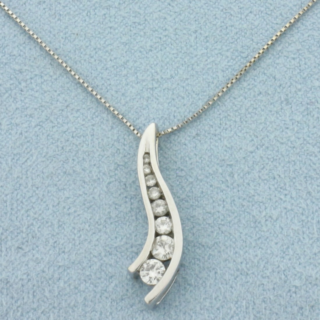 Diamond Journey Necklace in 14k White Gold: In 14k White Gold. Contains eight high quality round brilliant diamonds ranging from .1ct to .01ct, 1/3ct TW, H color/I clarity. Pendant is 7/8 inch long by 1/4 inch wide. Box link chain is 23 inches