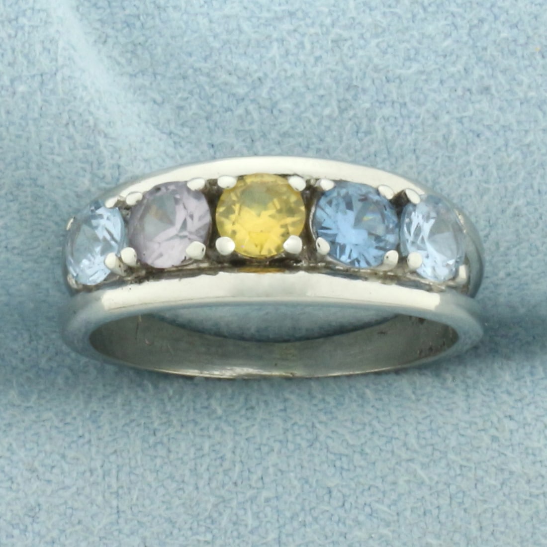 Multi Color Topaz Ring in 10k White Gold: In 10k White Gold. Contains five 4mm high quality Topaz gemstones in various colors, all with excellent clarity. 7mm wide at top. Size 7. 3.1g.