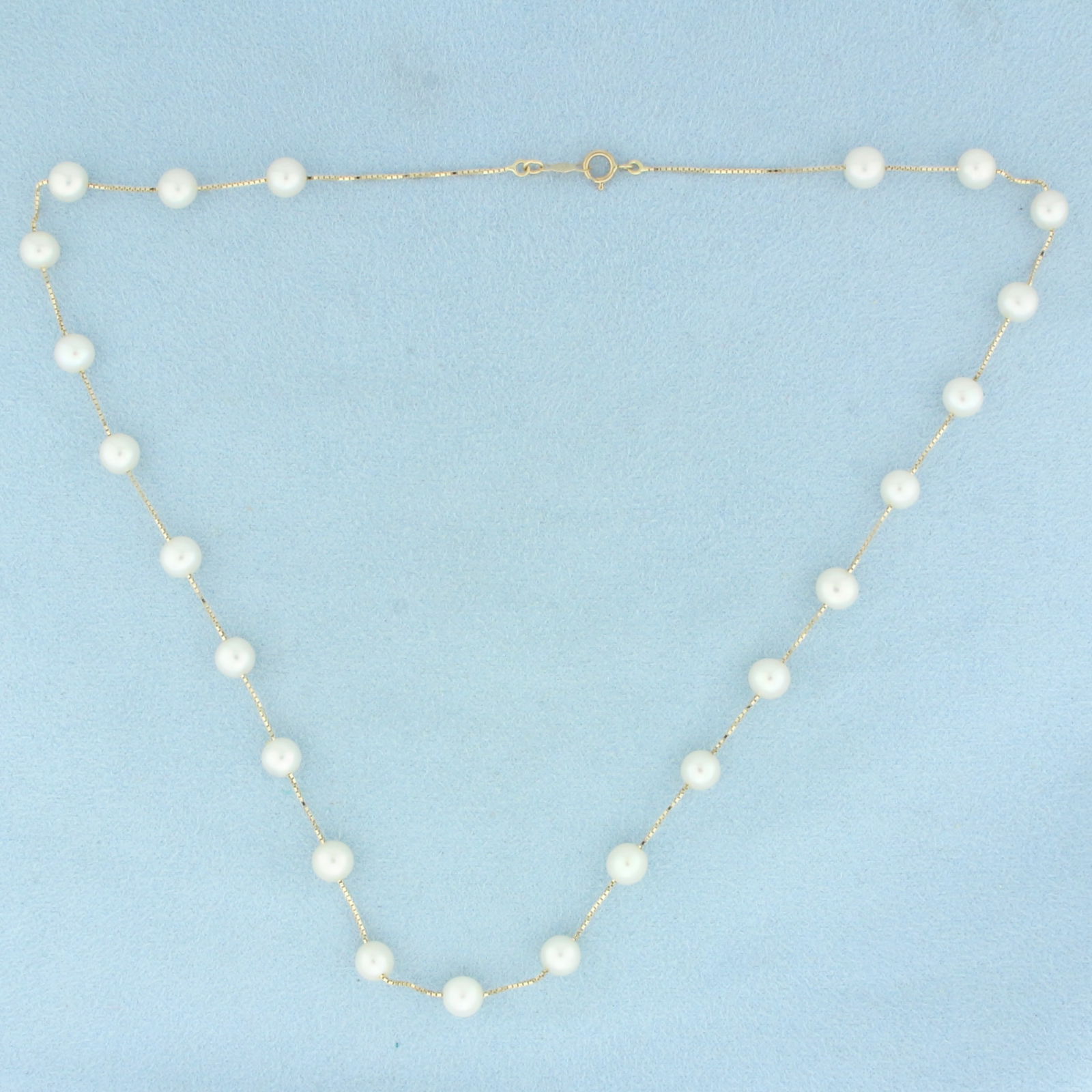Akoya Pearl Station Necklace in 14k Yellow Gold: In 14k Yellow Gold. Contains twenty three 5.5mm high quality Cultured Akoya Pearls with high luster. 17 inches long. Spring clasp. 7.1g.