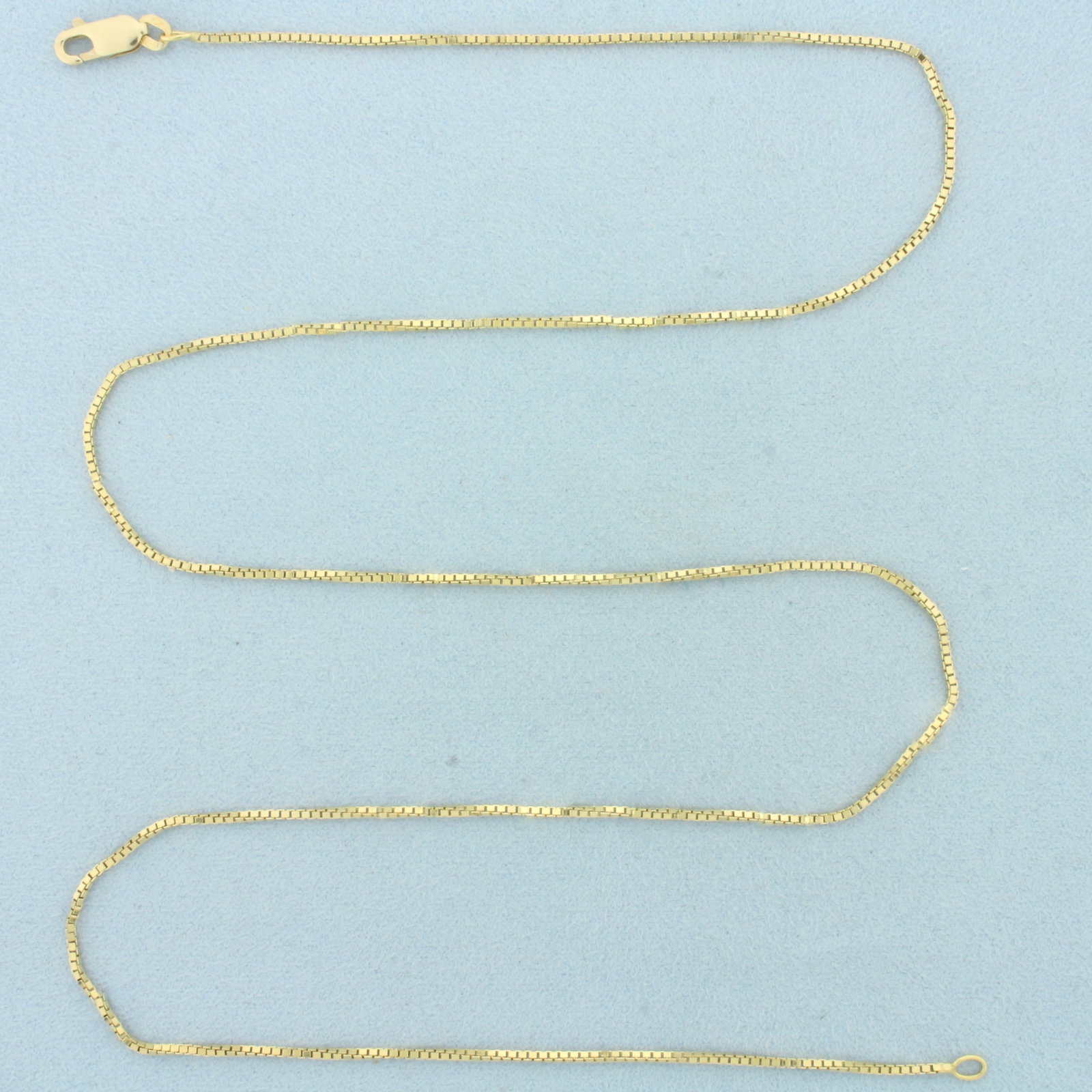 24 Inch Box Link Chain Necklace in 18k Yellow Gold: In 18k Yellow Gold. 24 inches long. 1.7mm wide. Box link. Lobster clasp. 7.9g.