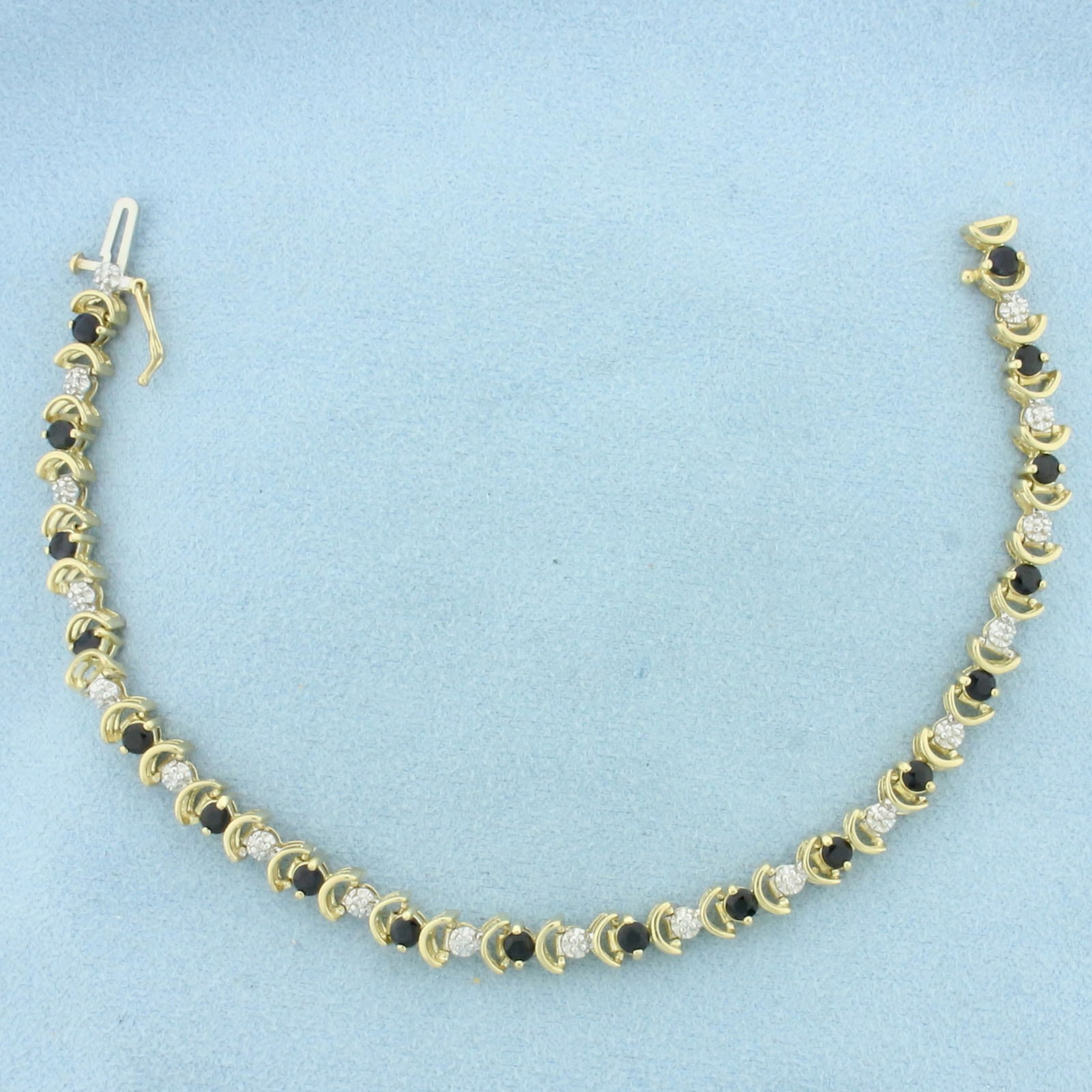 Sapphire and Diamond Tennis Bracelet in 10K Yellow Gold: In 10k yellow gold. Measures 7.5 inches long and 5.3mm wide. Contains 18 high quality natural 3mm Sapphire Gemstones, approximately 2ct TW, with deep color and excellent clarity. Also contains 18 high