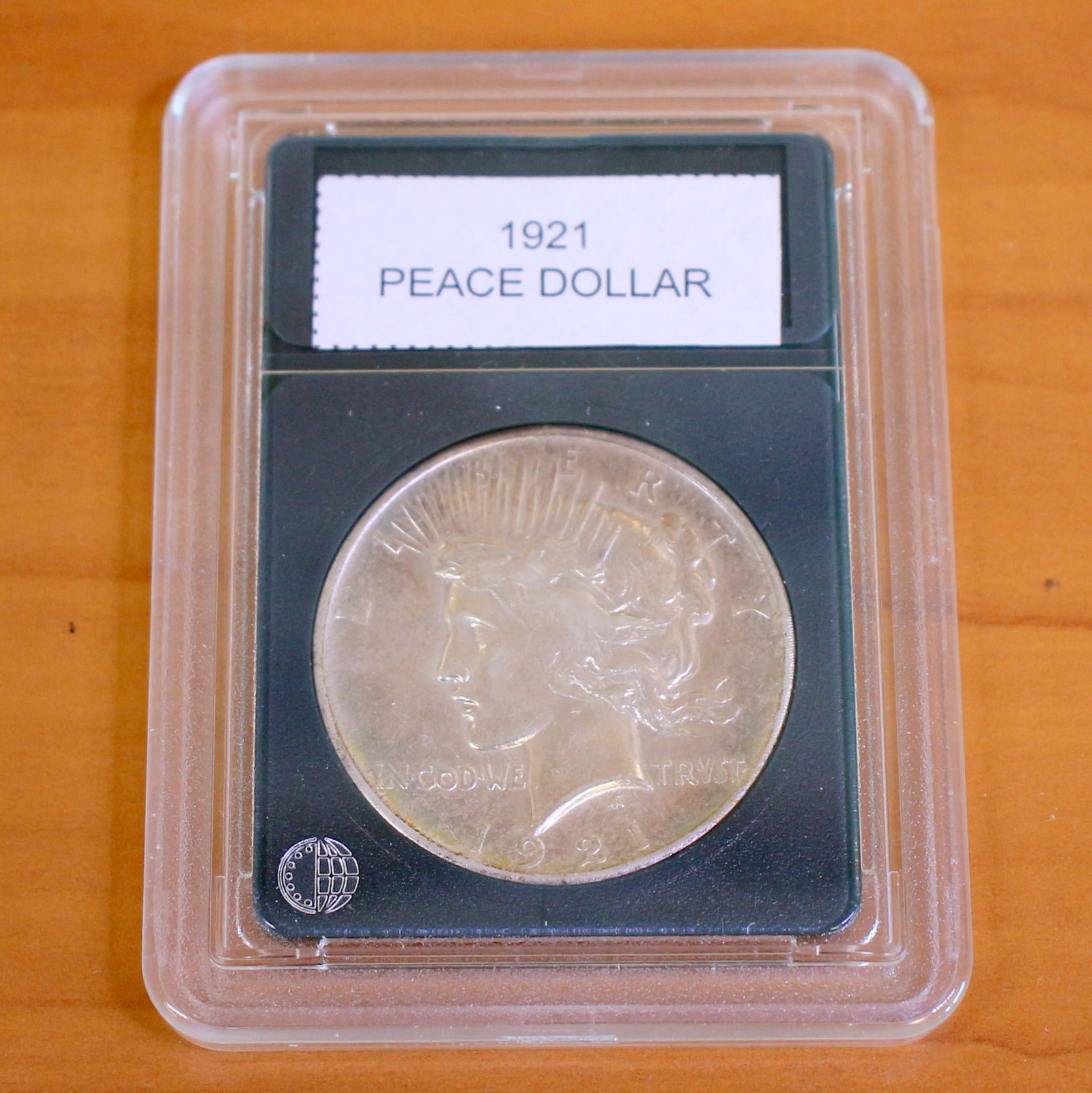 Peace Silver Dollar Coin in Slab: One coin from 1921-1935. Packaged by CoinWorld. Very Fine Condition. Picture of a sample coin, will get one in similar condition.