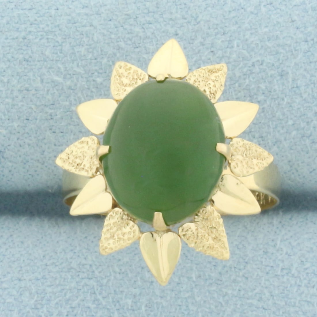 Jade Flower Design Ring in 14k Yellow Gold: In 14k Yellow Gold. Contains one 12mm high quality Jade gemstone with beautiful forest green color. Size 7. 3.0g.