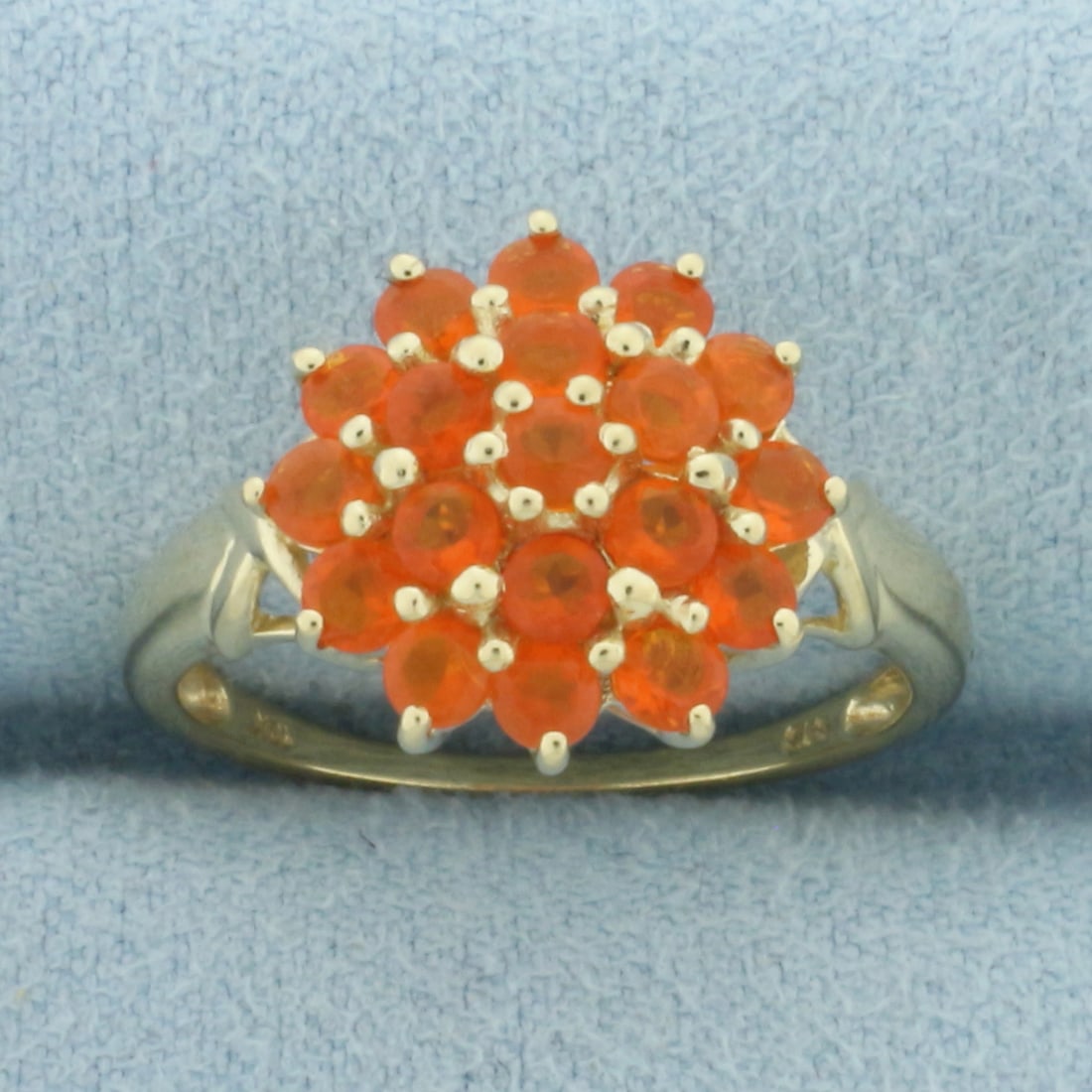 Fire Opal Flower Ring in 10k Yellow Gold: In 10k Yellow Gold. Contains nineteen 2.5mm high quality natural Fire Opal gemstones, with vibrant color and excellent clarity. 13.4mm wide at top of ring. Size 7. 2.7g.
