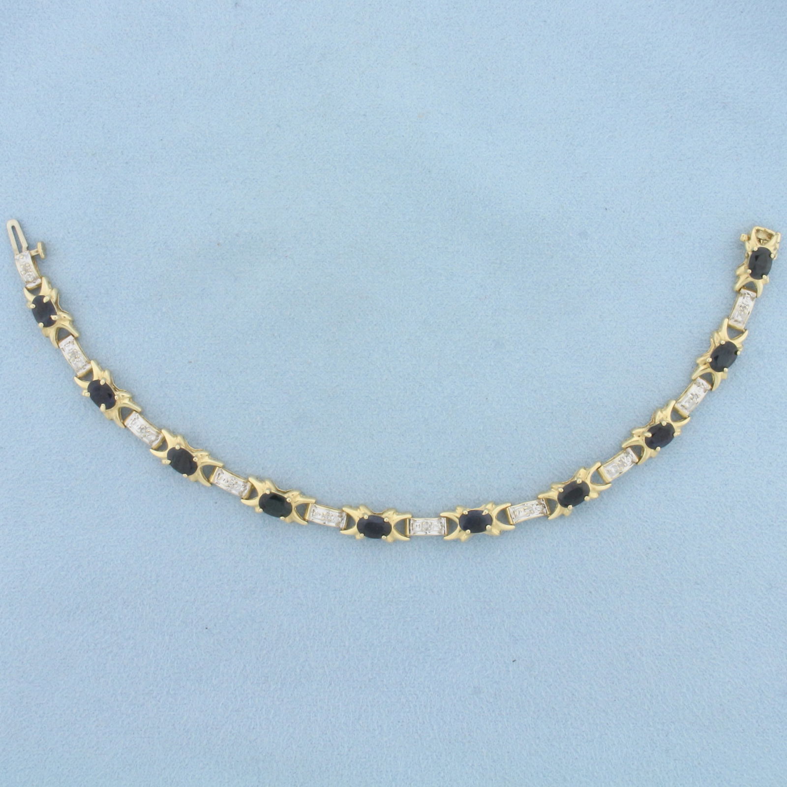 Natural Sapphire and Diamond Tennis Bracelet in 14K Yellow Gold: In 14K Yellow Gold. Contains ten high quality natural 4mmx6mm oval cut Sapphire gemstones with deep blue color and excellent clarity. Also contains ten high quality 1/2pt Diamonds. 7 inches long. 6.4m