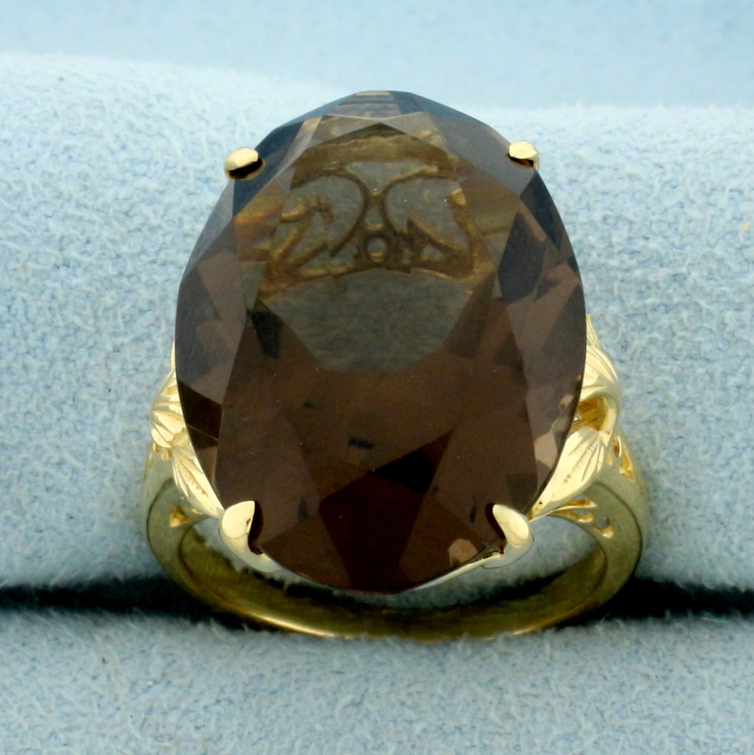 24ct Smoky Topaz Statement Ring in 14K Yellow Gold: In 14K Yellow Gold. Contains one high quality natural 22x15.5mm oval cut Smoky Topaz gemstone with intense smoky color and excellent clarity. Size 7 1/2. 8.6g