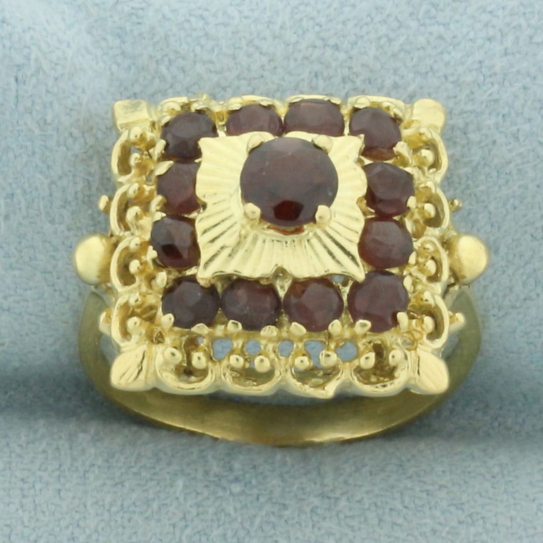 Vintage Garnet Ring in in 18k Yellow Gold: In 18k yellow gold. Contains thirteen high quality natural Garnet Gemstones, over 1ct TW, with beautiful deep color and excellent clarity. Size: 6.5. 6.3g.