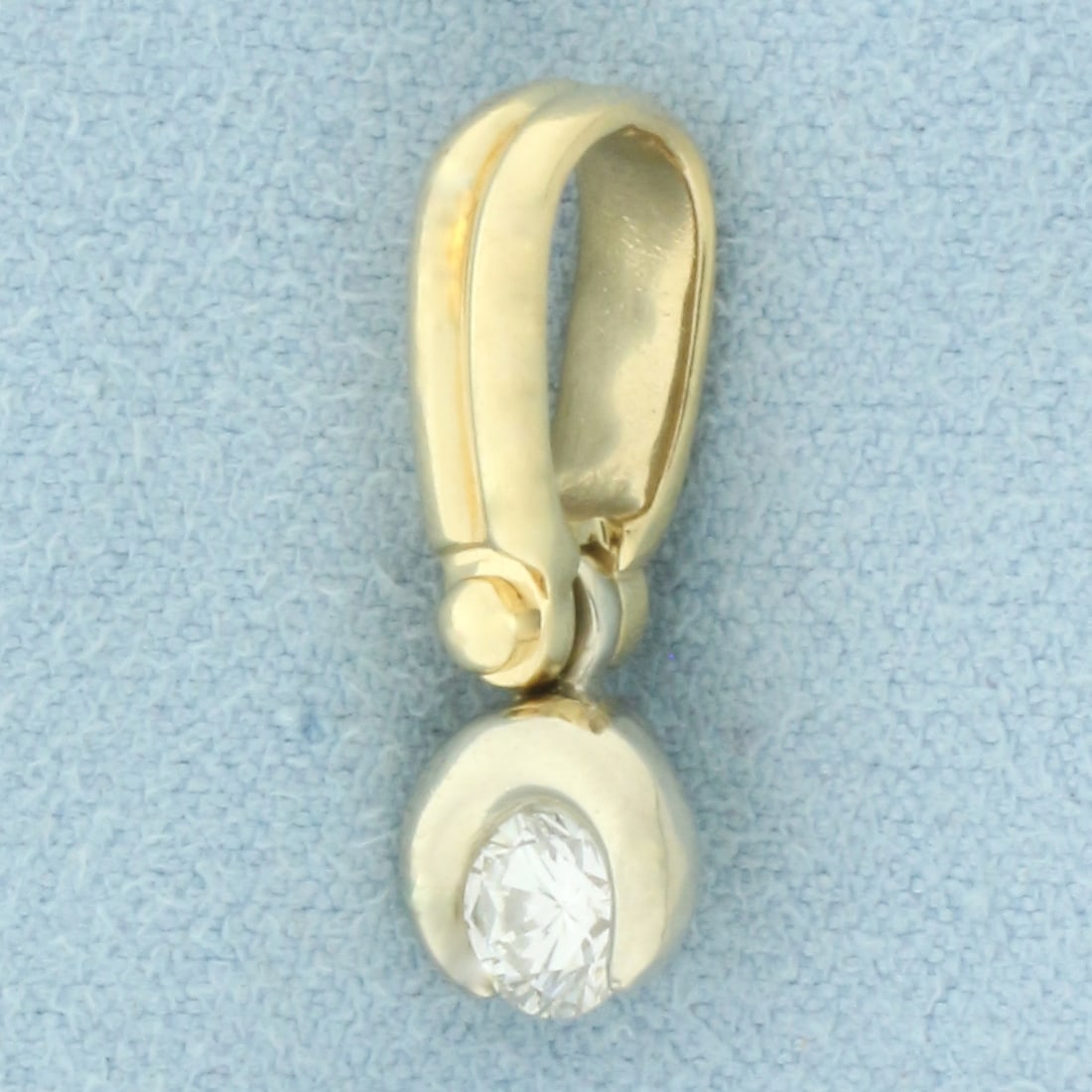 Diamond Swinging Mechanical Pendant in 14k Yellow and White Gold: In 14k yellow and white gold. Contains one high quality 1/2ct round brilliant diamond, VS clarity/H color. 3/4 inches long and 1/4 inches wide. Diamond can swing side to side. 2.7g.