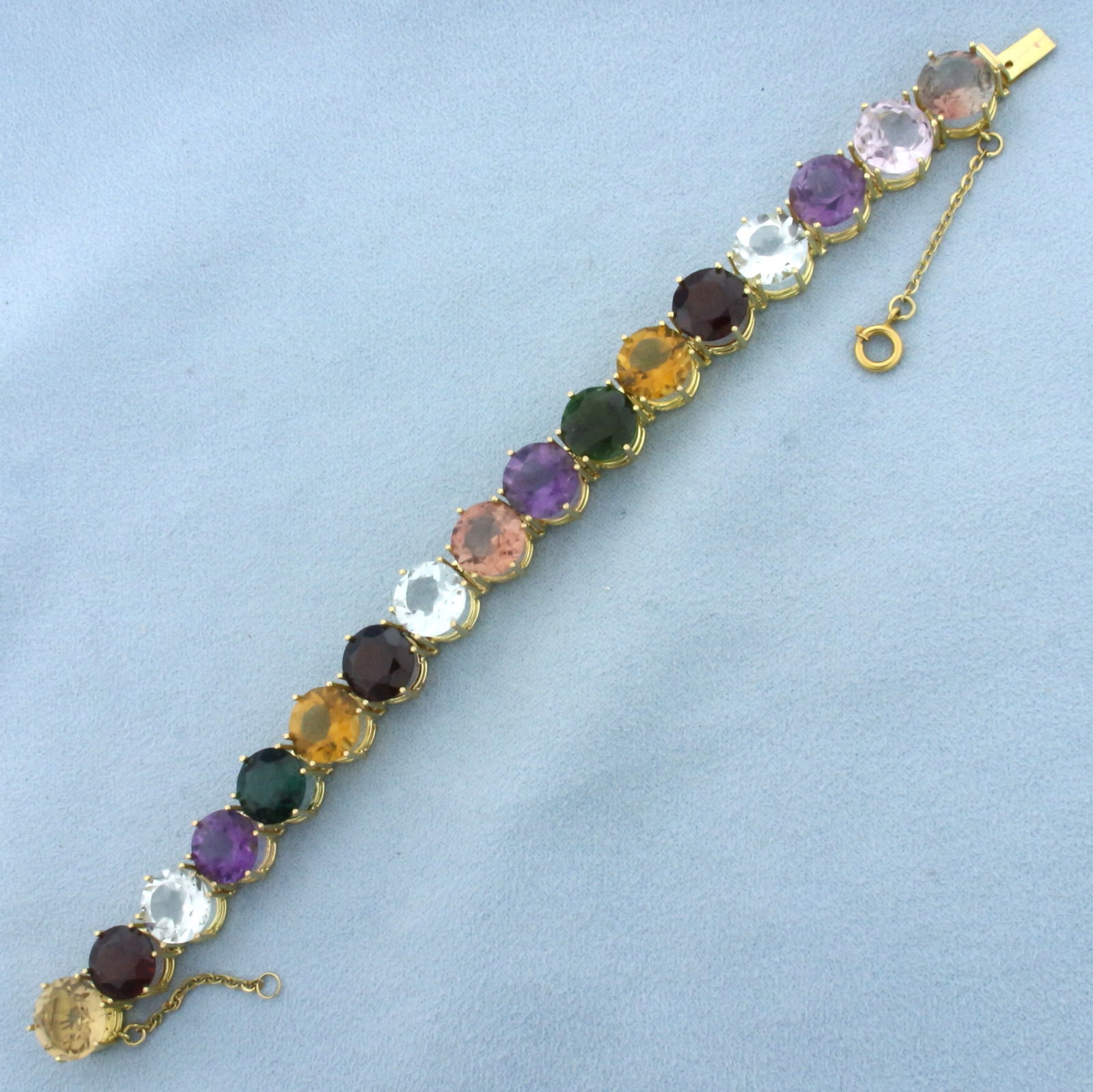 Huge Multi Gemstone Tennis Line Bracelet in 18k Yellow Gold: In 18k Yellow Gold. Contains 10mm high quality natural gemstones including citrine, garnet, white topaz, amethyst, aquamarine, green garnet, quartz, and morganite, all with intense color and excellent