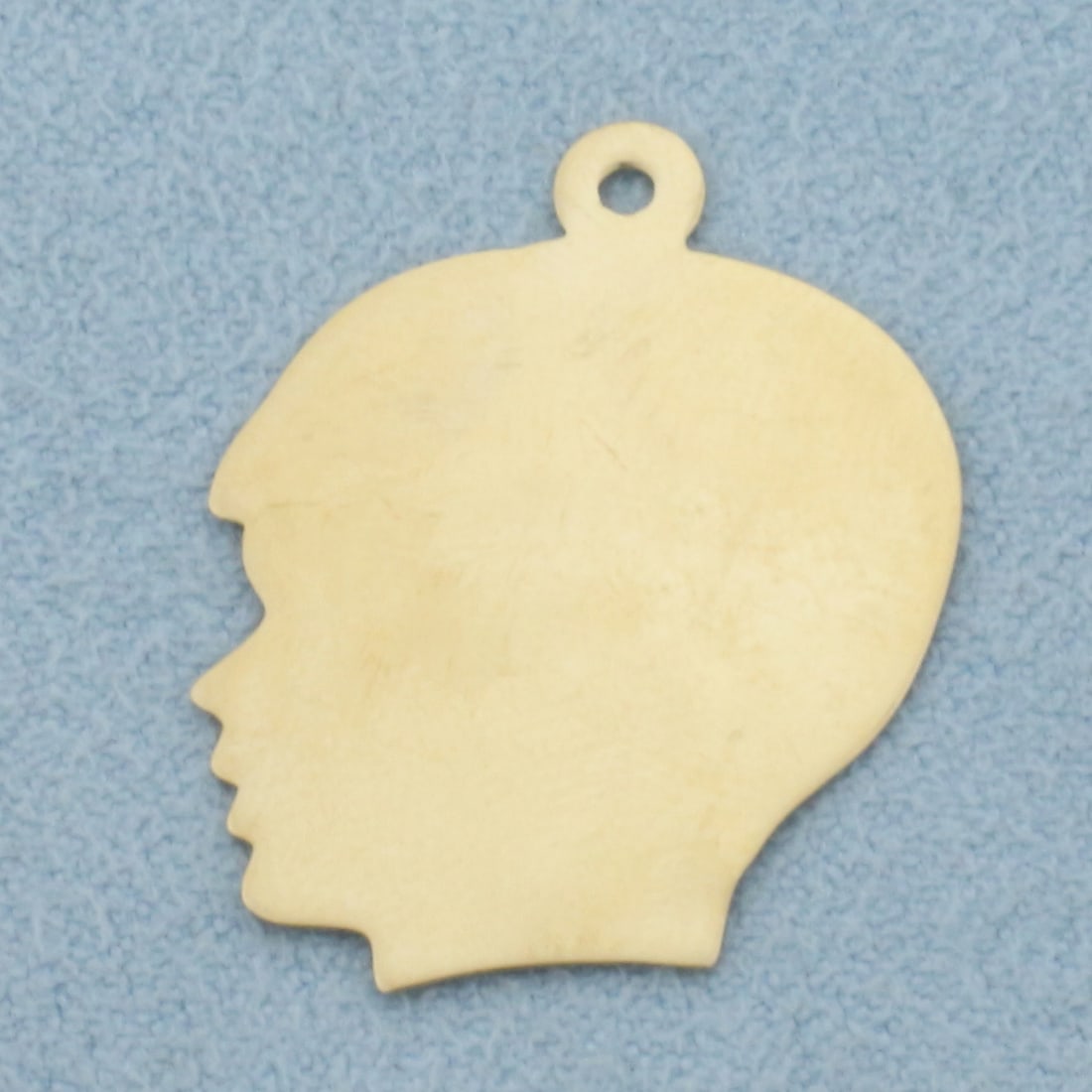 Engravable Boy Silhouette Pendant or Charm in 14k Yellow Gold: In 14k Yellow Gold. 1 inch long. 3/4 inch wide. Can engrave on either side. 1.4g.