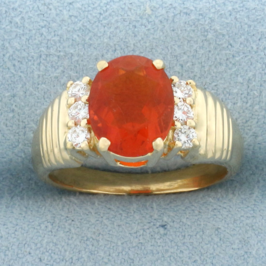 Fire Opal and Diamond Ring in 18k Yellow Gold: In 18k Yellow Gold. Contains one high quality natural 10mmx8mm fire opal with vibrant color and excellent clarity. Also contains six .03ct diamonds, VS clarity/G color. Size 7.5. 6.6g.