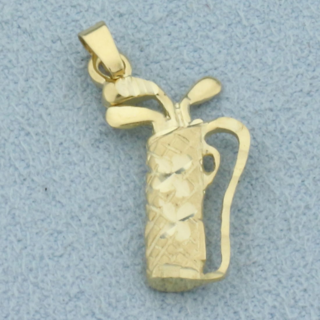 Golf Clubs Charm or Pendant in 14k Yellow Gold: In 14k Yellow Gold. 7/8 inch long including bale. 1/2 inch wide at widest. 1.7g.