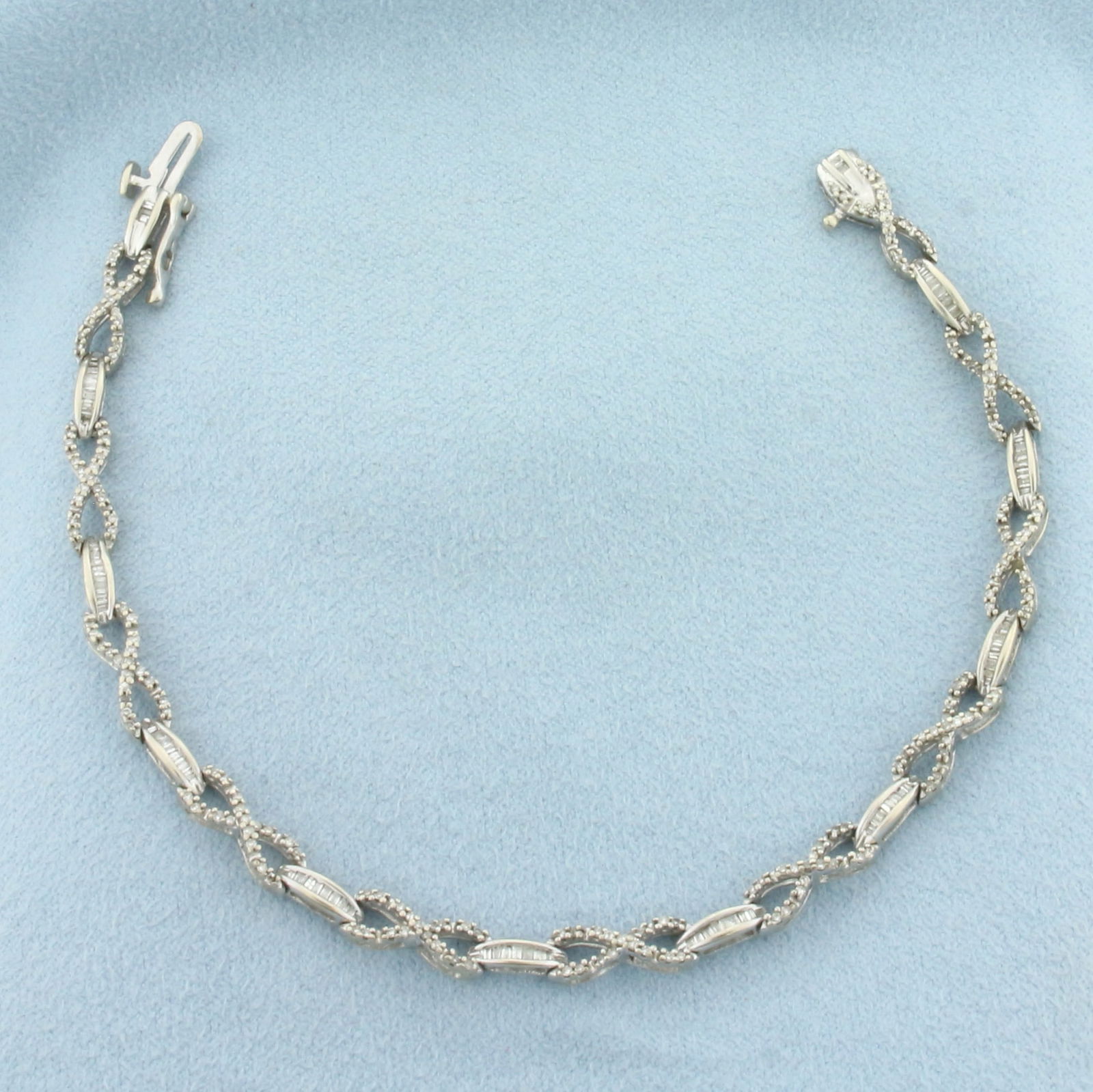 Diamond Infinity Link Bracelet in 10k White Gold: In 10k White Gold. Contains 363 round and 88 baguette high quality diamonds, 1ct TW, SI clarity/H color. 7.9g.
