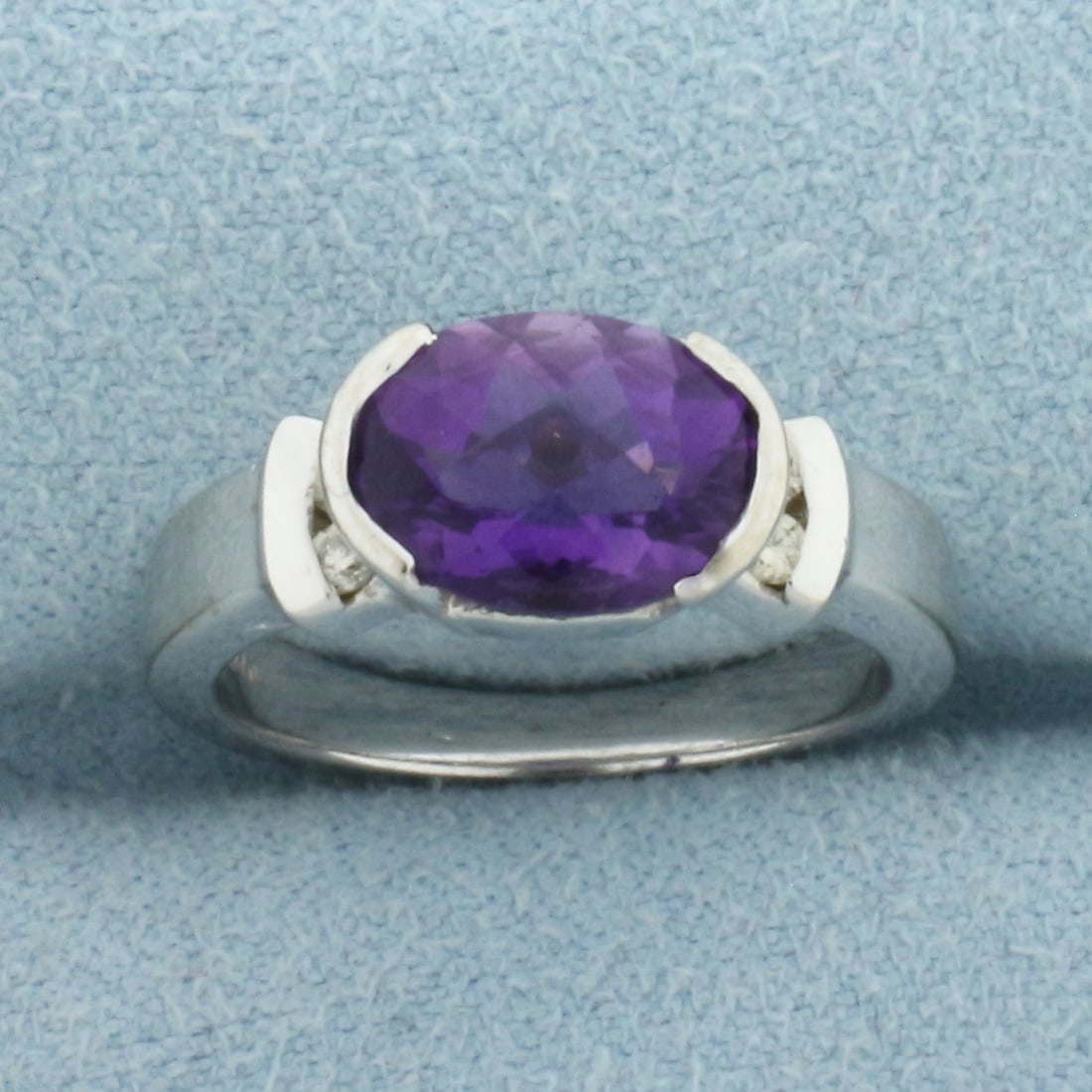 Checkerboard Amethyst and Diamond Ring in 14k White Gold: In 14k White Gold. Contains one 10mm natural fancy checkboard cut Amethyst gemstone with intense color and excellent clarity. Also contains four high quality .01ct diamonds, SI clarity/H color. Size 4
