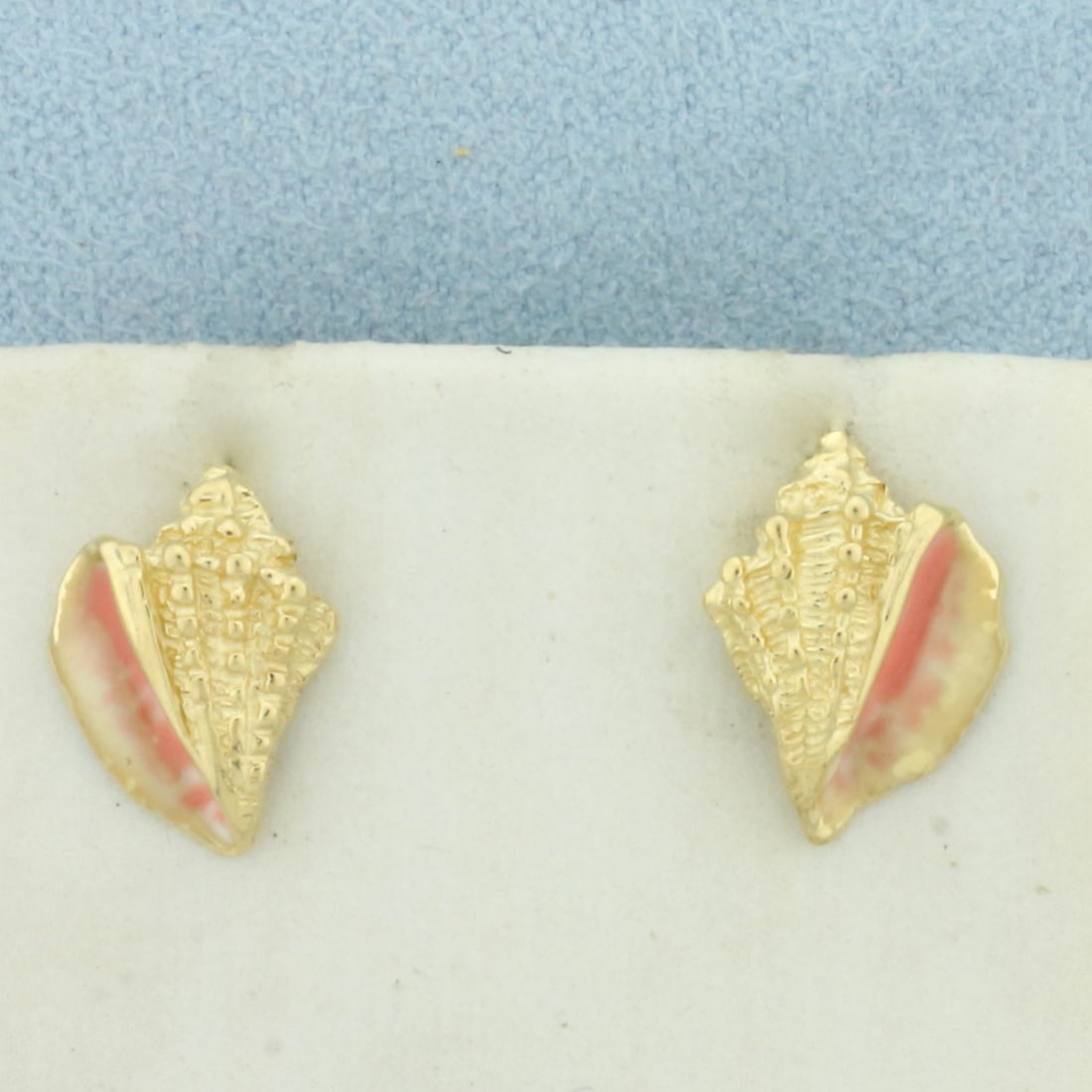 Enamel Conch Shell Earrings in 14k Yellow Gold: In 14k Yellow Gold. 1/2 inch long. 3/8 inch wide. Enamel detail to give realistic shell look. Friction backs. 2.7g.