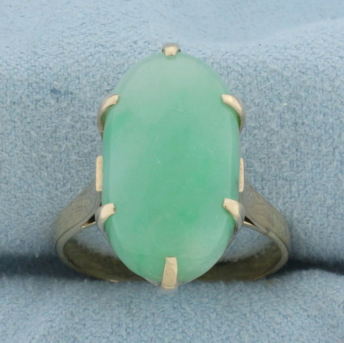 Jade Solitaire Statement Ring in 14k Yellow Gold: In 14k Yellow Gold. Contains one 19x11mm high quality natural Jade gemstone with beautiful bright green color. Size 8.5. 6.3g.