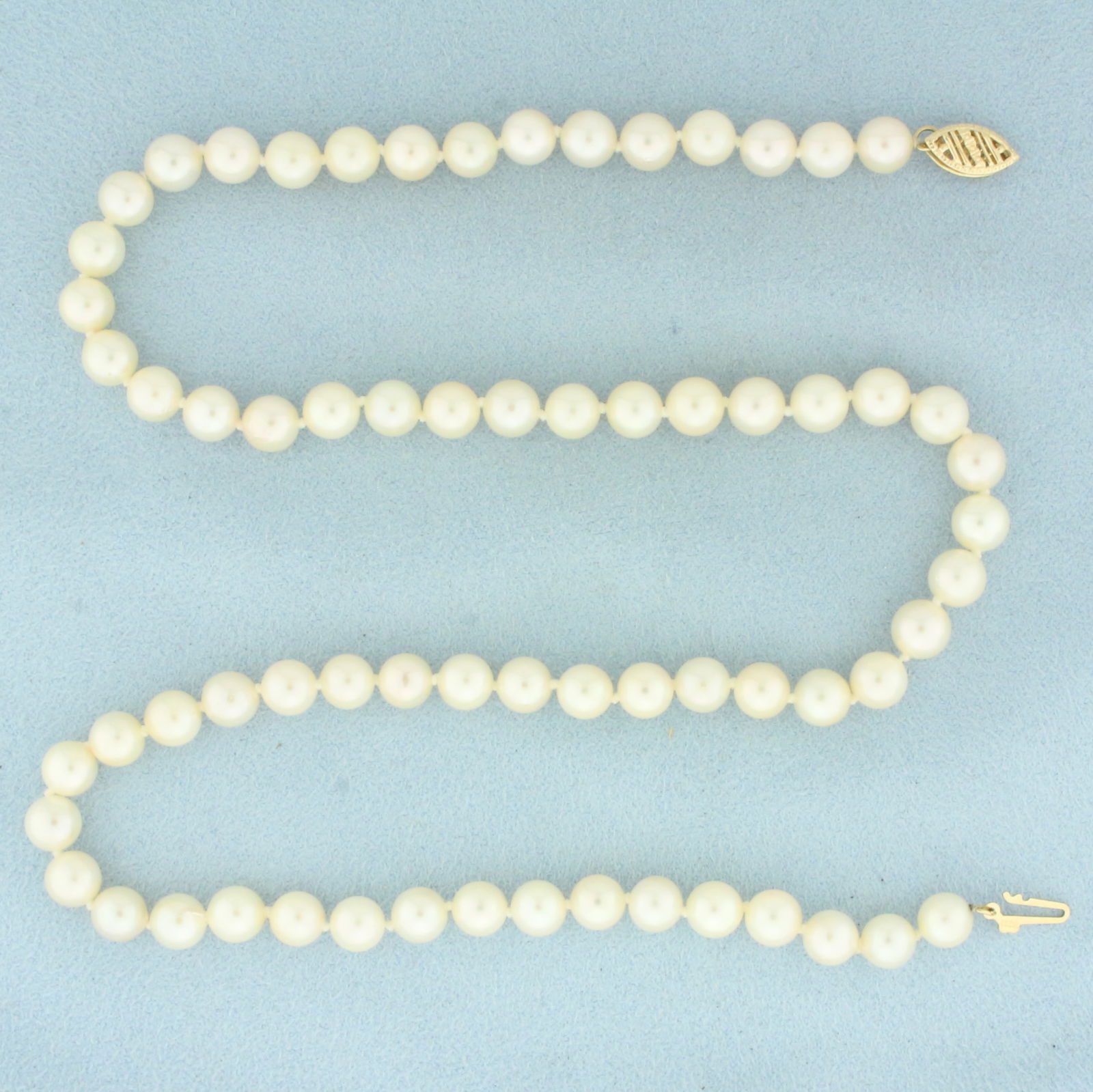 Akoya Pearl Strand Necklace in 14k Yellow Gold: In 14k Yellow Gold. Contains 6mm high quality Cultured Akoya Pearl gemstones with high luster. 18 inches long. Hand knotted. Decorative locking filigree clasp. 22.3g