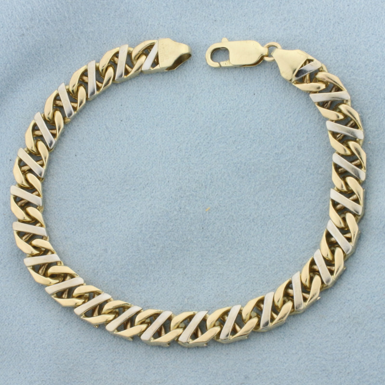 Mens Two Tone Curb Link Bracelet in 10k Yellow and White Gold: In 10k Yellow and White Gold. 8 inches long. 7mm wide. Lobster clasp. 22.3g.