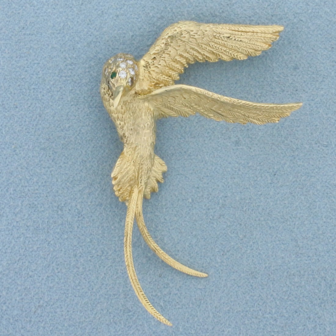 Hummingbird Emerald and Diamond Brooch Pin in 14k Yellow Gold: In 14k Yellow Gold. Contains two 1.3mm high quality natural Emerald gemstones with vibrant color and excellent clarity. Also contains fifteen .01ct TW high quality diamonds, VS clarity/F color. 2 1/8