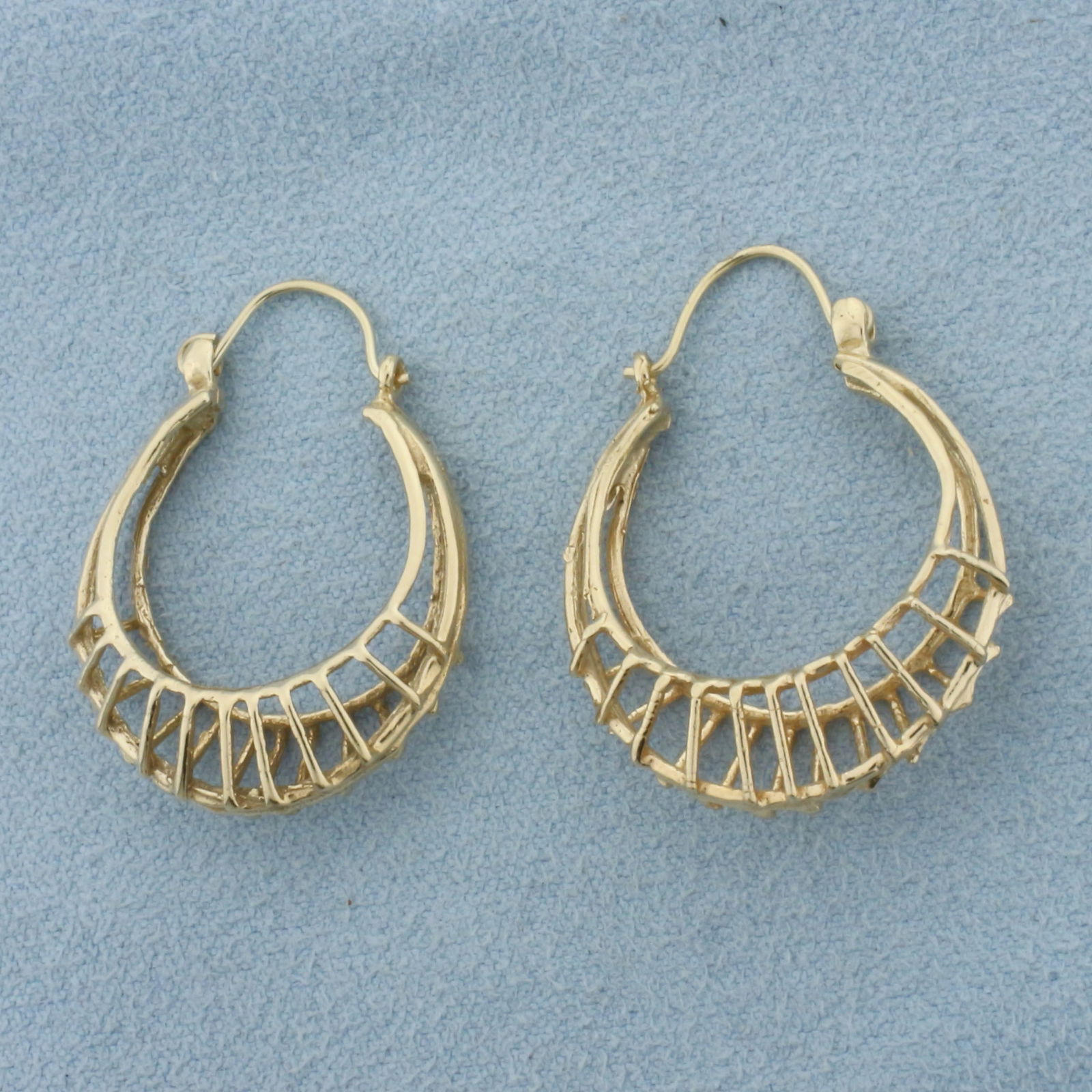 Birdcage Hoop Earrings in 14k Yellow Gold: In 14k Yellow Gold. 1 1/8 inch long. 7/8 inch wide profile. Leverback. 4.8g.