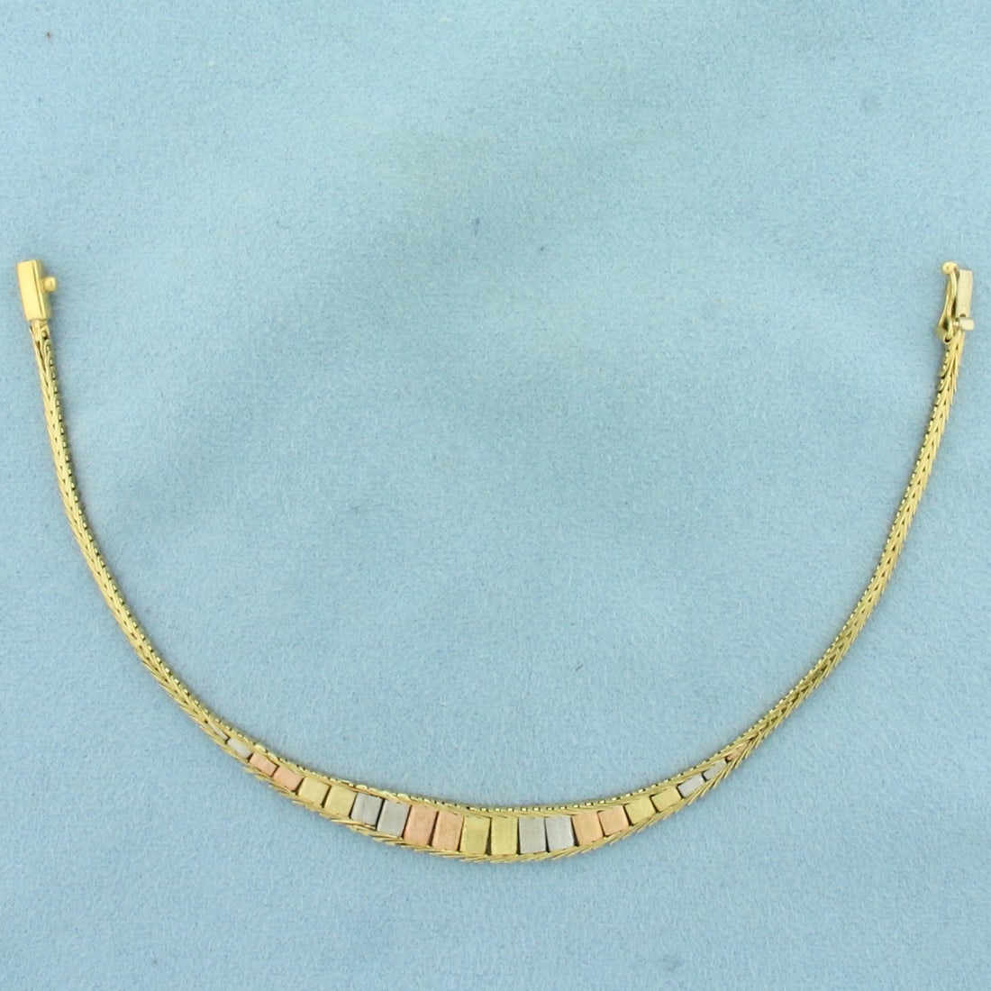 Italian Tri-Color Bar Link Bracelet in 14k Yellow, White, and Rose Gold: In 14k Yellow, White, and Rose Gold. 7 1/4 inches long. 1/4 inch wide at center. Italian made. Slide clasp with safety latch. 5.6g.