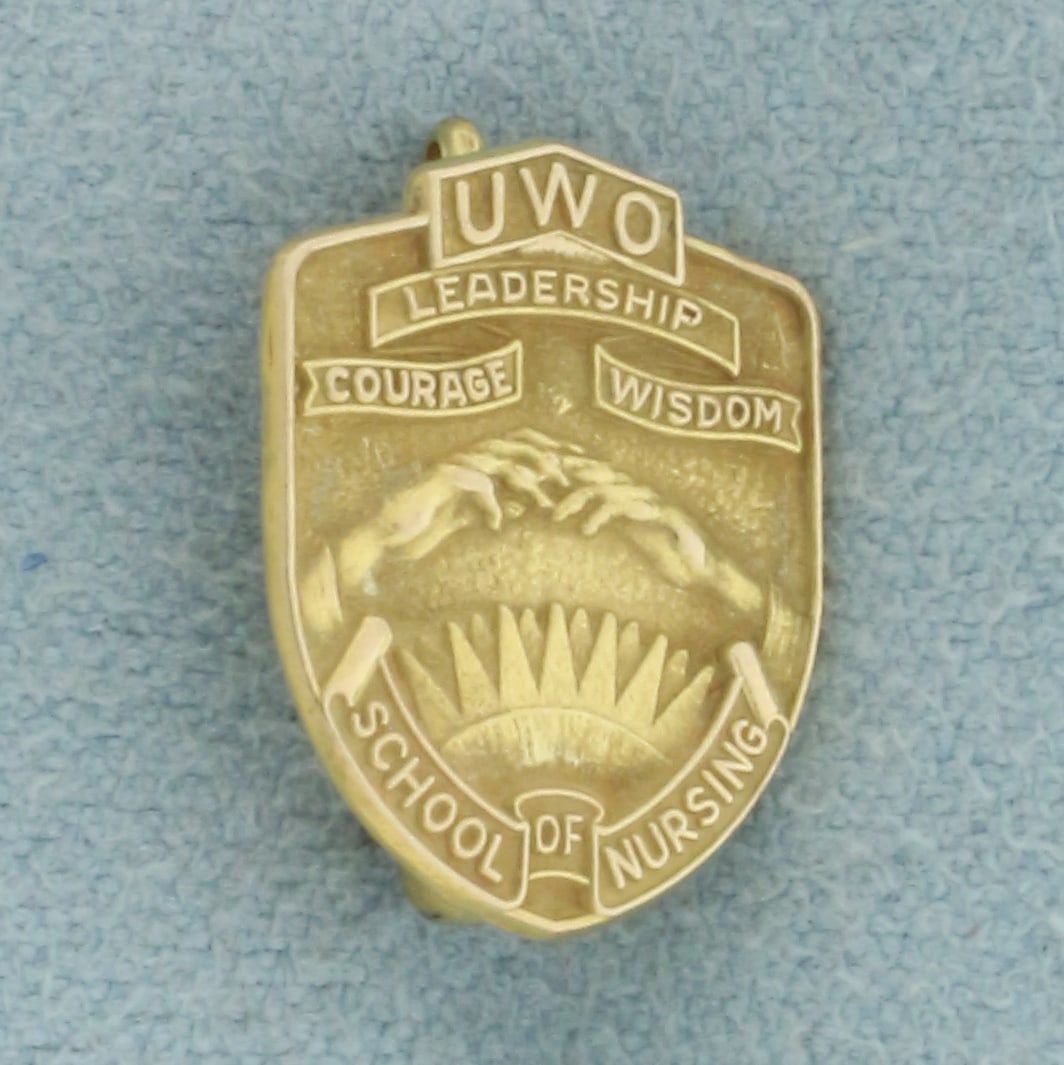 UWO School of Nursing Pin in 10k Yellow Gold: In 10k Yellow Gold. 5/8 inch long. 1/2 inch wide. 1.3g.
